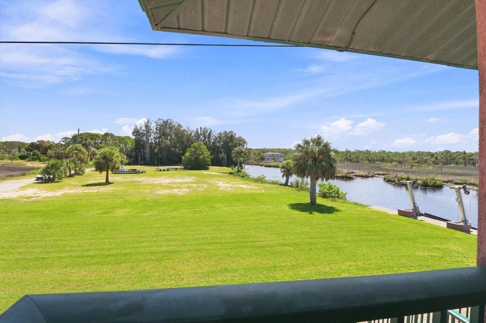 Waterfront grounds with broad lawn area and direct water frontage. - 3198 INDIAN GULF LN, HERNANDO BEACH
