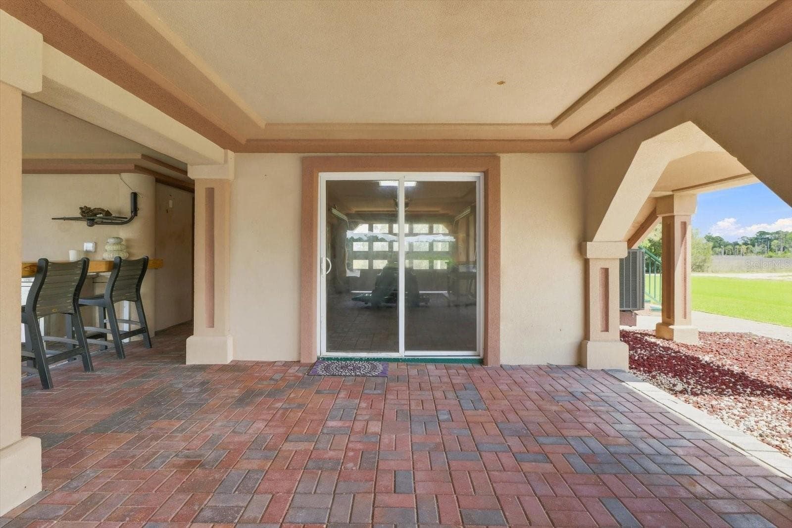 Covered ground-level patio with direct access through sliding glass doors. - 3198 INDIAN GULF LN, HERNANDO BEACH