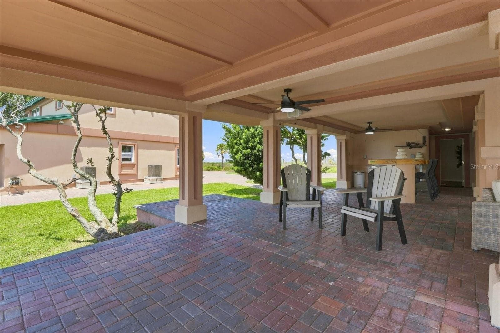 Covered patio extending across the ground level of the residence. - 3198 INDIAN GULF LN, HERNANDO BEACH