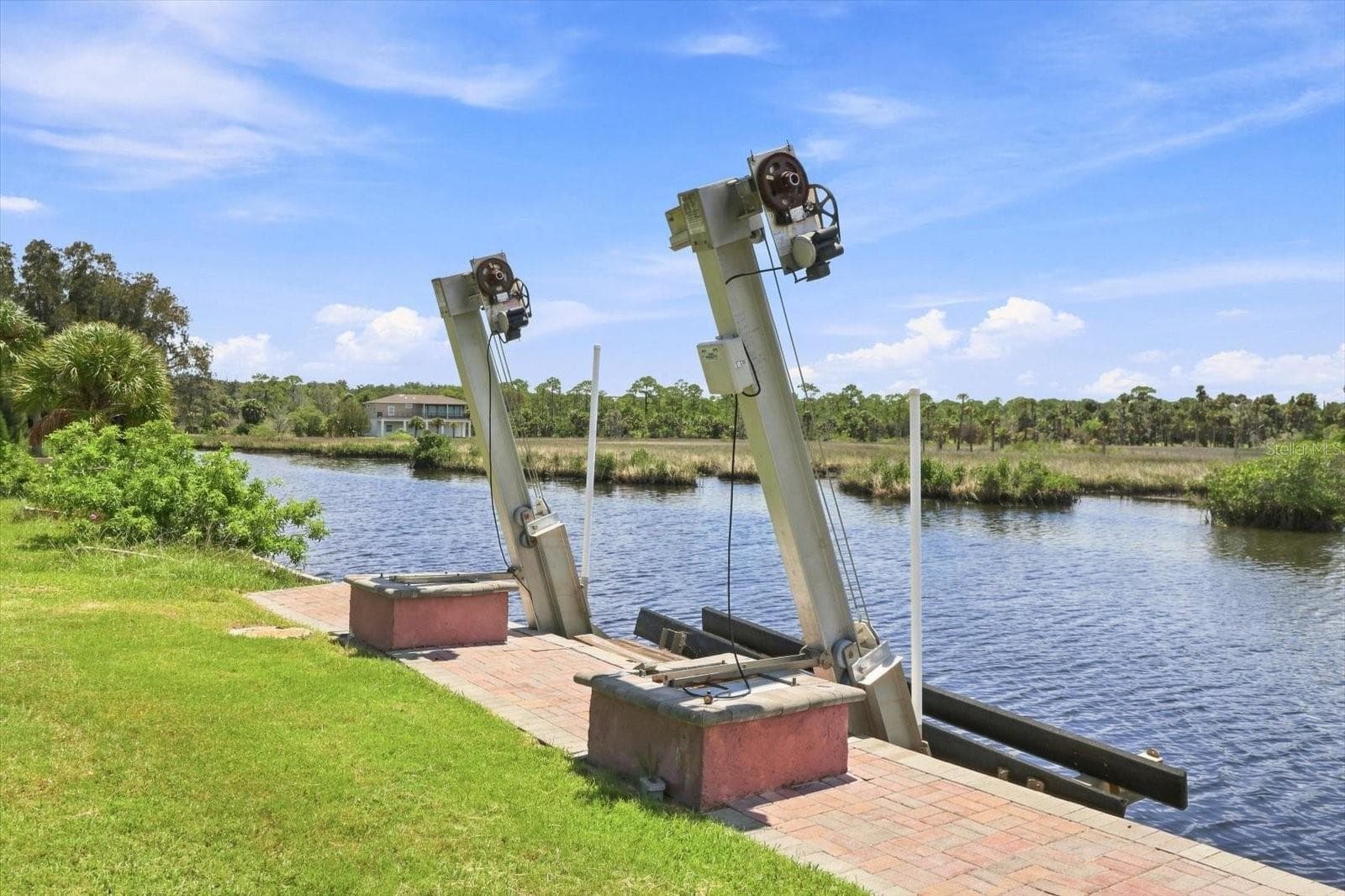 Seawall-mounted boat lift providing convenient vessel storage and direct water access. - 3198 INDIAN GULF LN, HERNANDO BEACH
