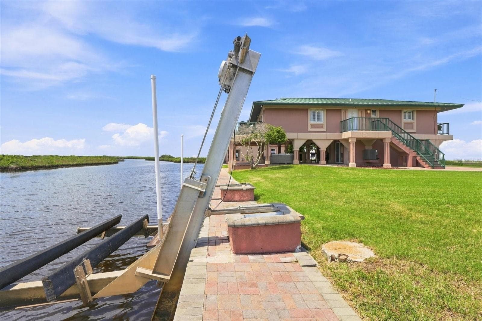 Seawall-mounted boat lift providing convenient vessel storage and direct water access. - 3198 INDIAN GULF LN, HERNANDO BEACH