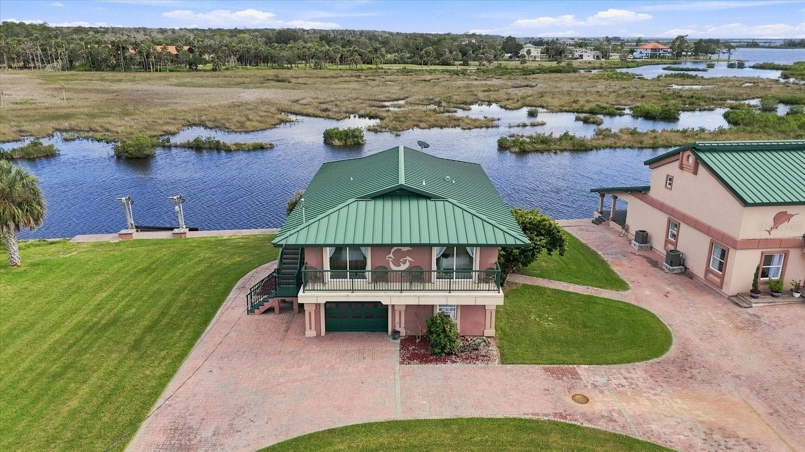 Elevated aerial showing the residence positioned directly along the waterfront. - 3198 INDIAN GULF LN, HERNANDO BEACH