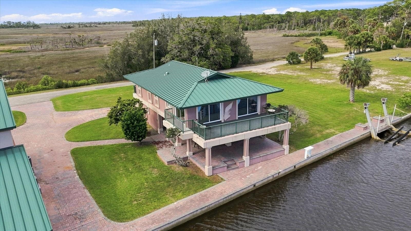 Aerial perspective highlighting the residence, seawall, lawn, and water frontage. - 3198 INDIAN GULF LN, HERNANDO BEACH