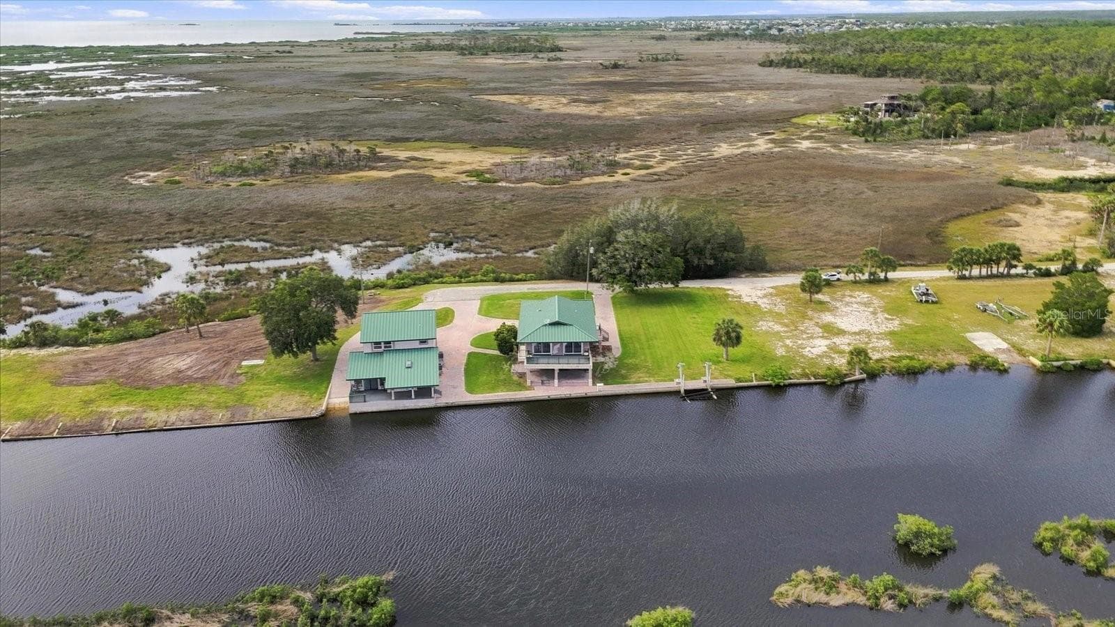 Wide aerial illustrating the property's waterfront position within the surrounding coastal environment. - 3198 INDIAN GULF LN, HERNANDO BEACH