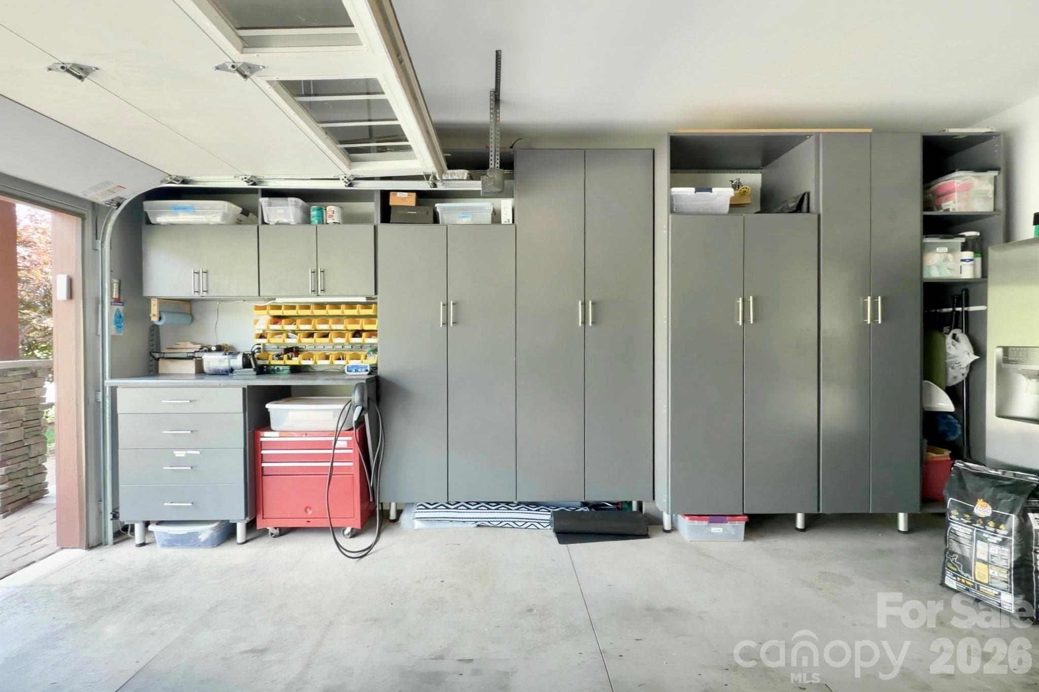 Garage with built-in cabinets and 220V for EV Charging - 16 Britton Knoll Pass, Arden