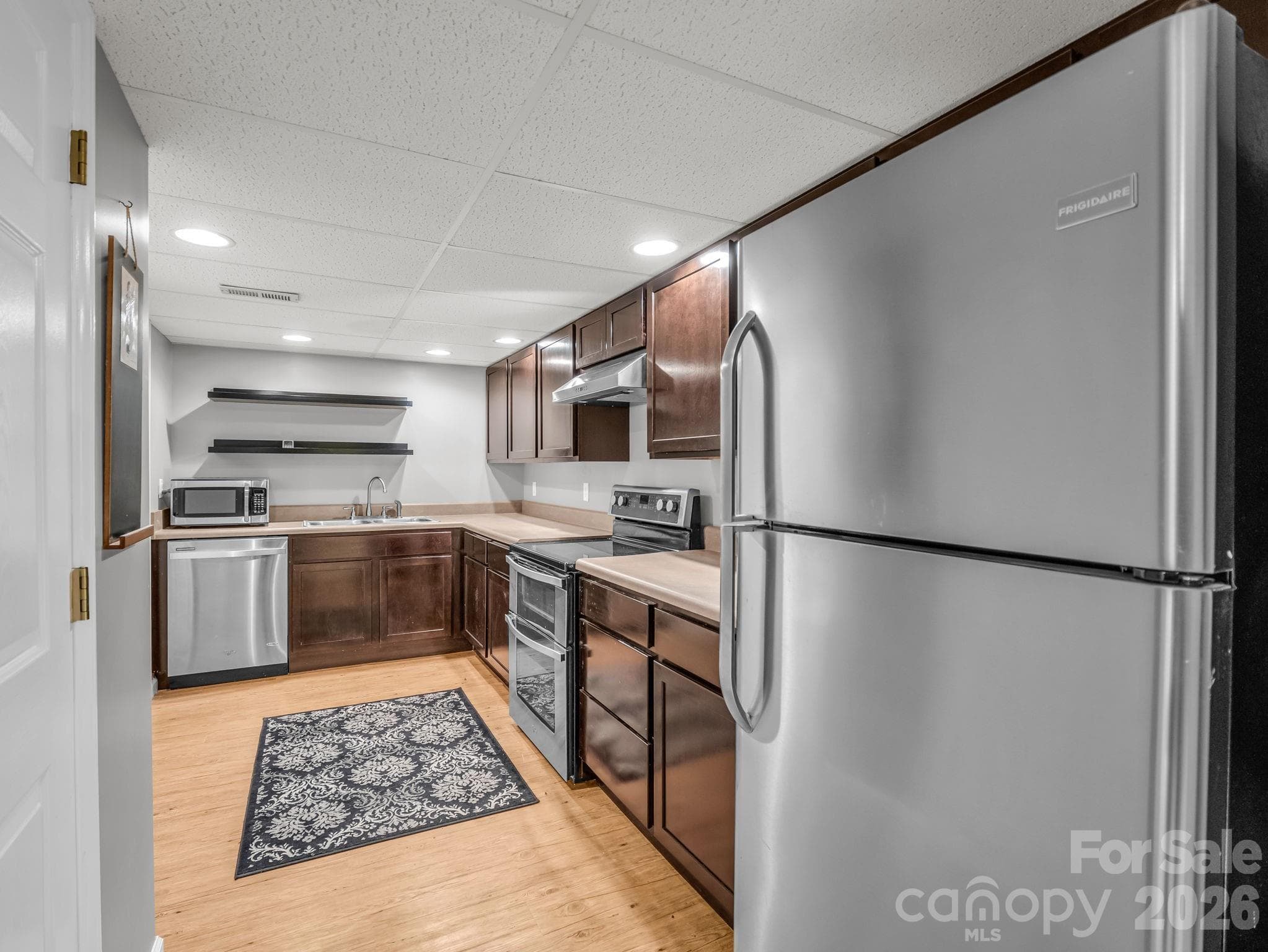 Lower level kitchen with stainless appliances - 335 Melrose Avenue, Tryon