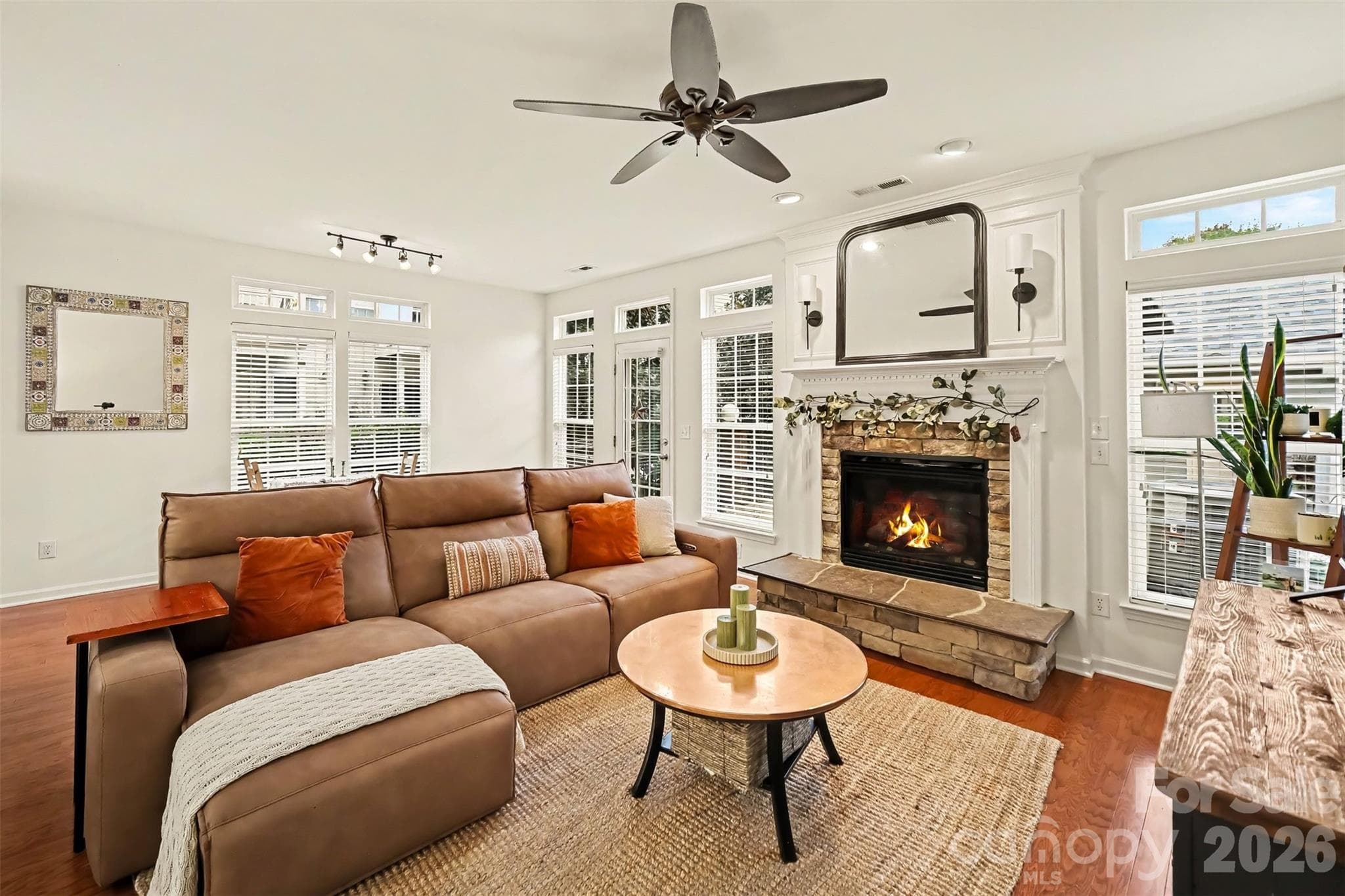 Cozy yet spacious family room with wood floors and stone fireplace - 438 Magnolia Street, Davidson