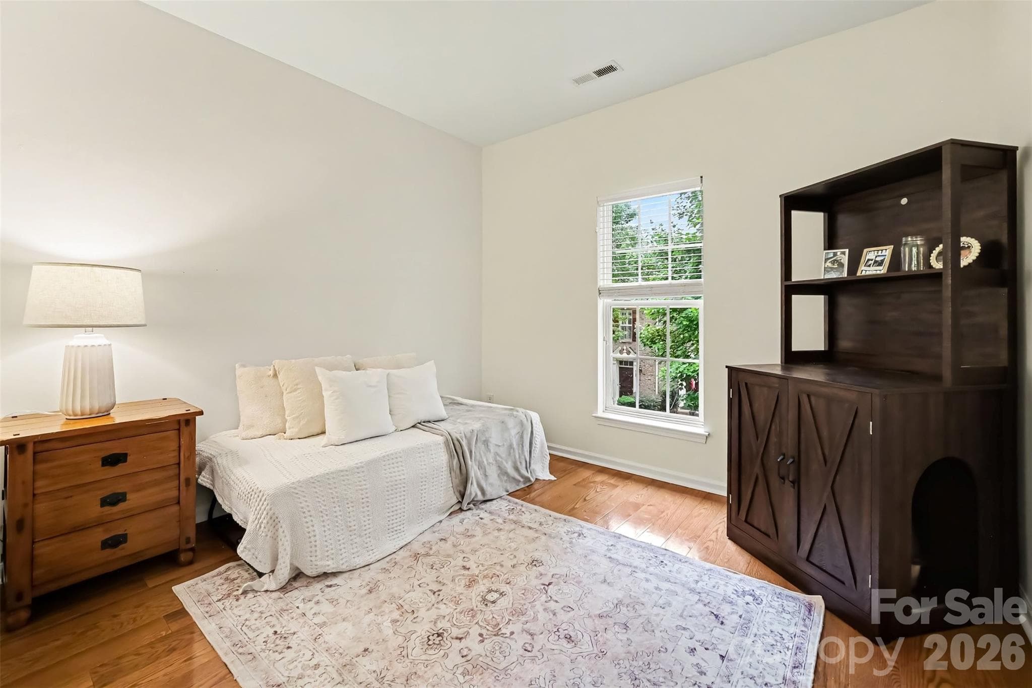 Secondary bedroom has wood floors and the hallway upstairs does too - 438 Magnolia Street, Davidson