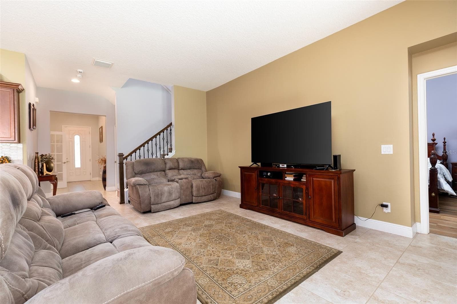 The primary bedroom is off the living room on the first floor - 995 KARST TREE LN, APOPKA