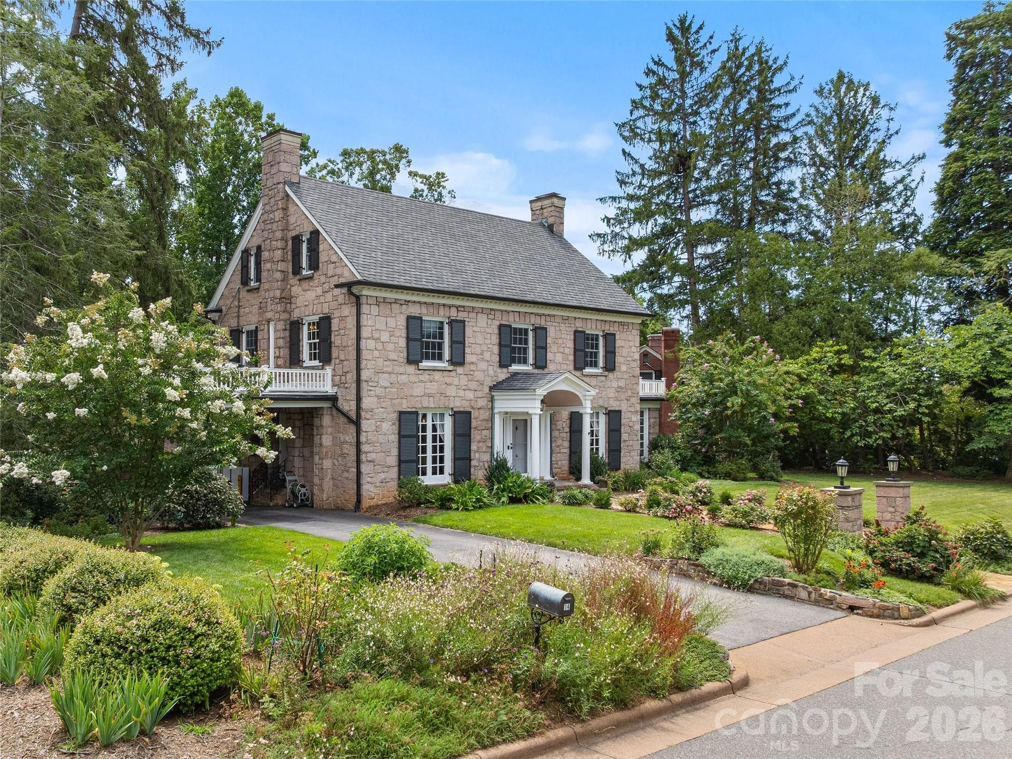 Beautifully landscaped grounds frame the historic stone home. - 14 Griffing Boulevard, Asheville
