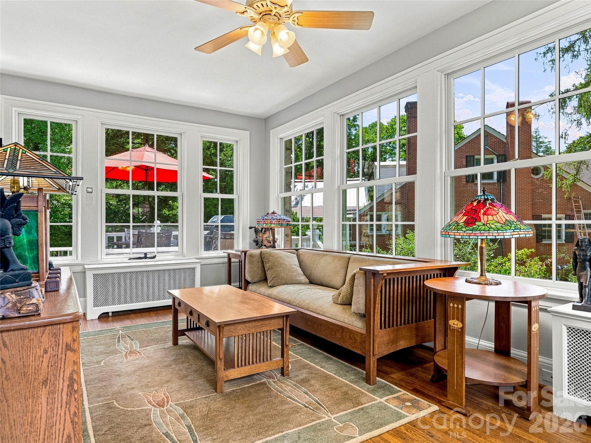 Bright sunroom surrounded by windows and garden views - 14 Griffing Boulevard, Asheville