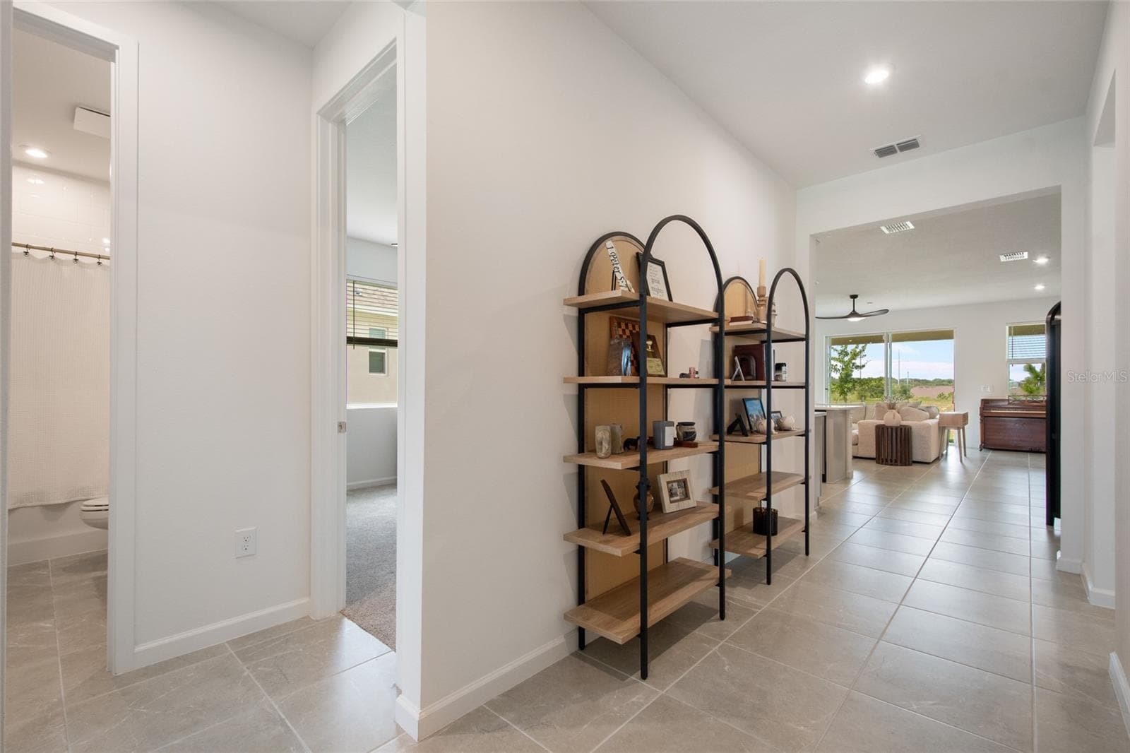 Immediately upon entering the two supporting bedrooms ( bedroom 2 and 3) are on the left with a full size bathroom in the hallway to support both bedrooms. - 2685 SWEET ACACIA DR, CLERMONT