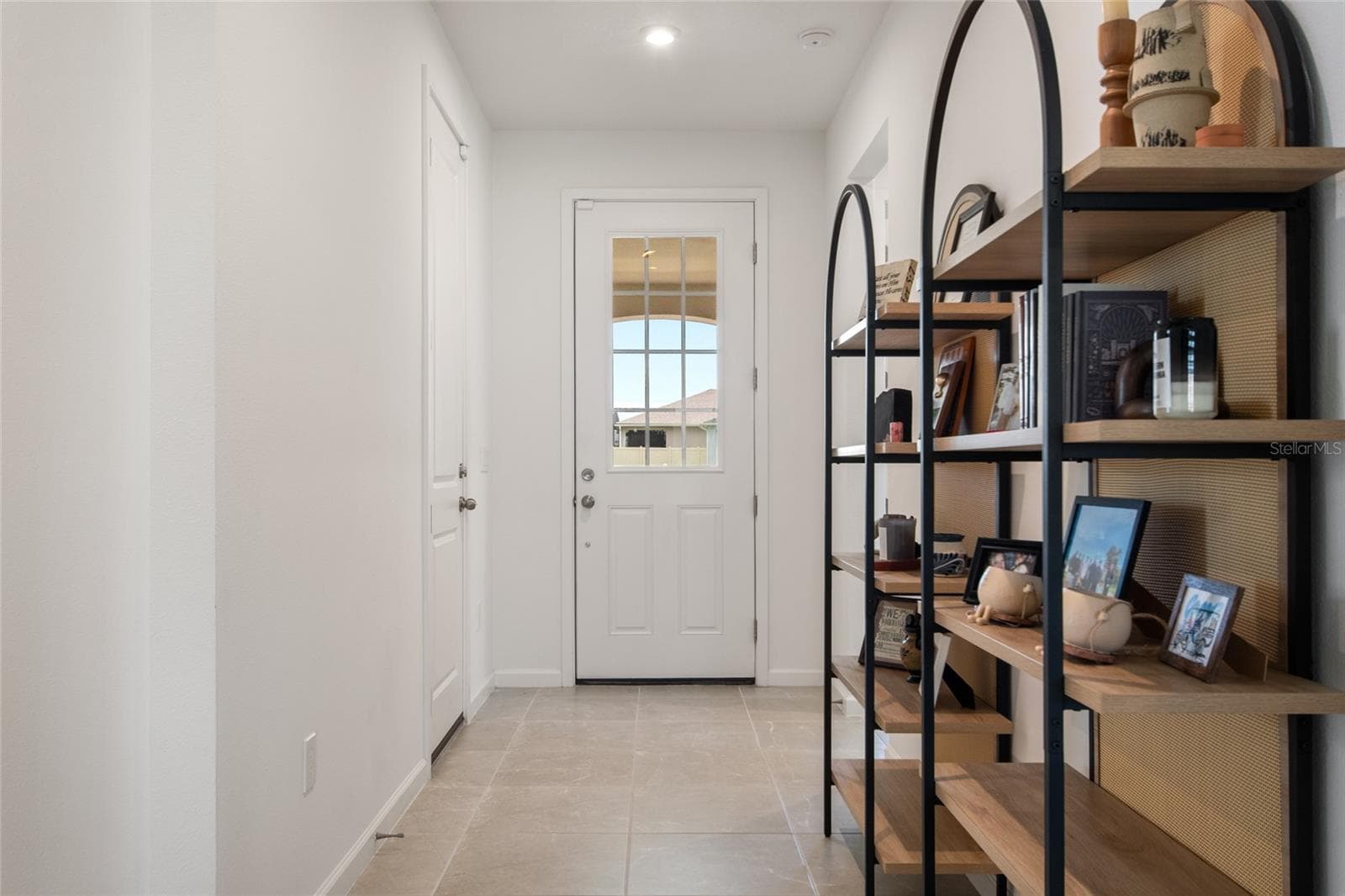 when standing in the foyer looking back at front door the Bedroom 4 hallway, bath and laundry are to your left and the Bedroom 2 & 3 with their bath are on your right. - 2685 SWEET ACACIA DR, CLERMONT