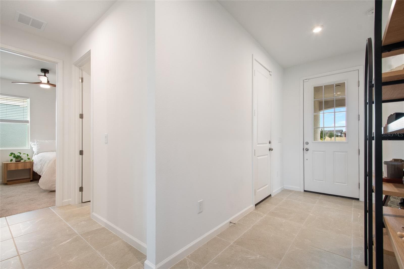 A view back at the front door the third bedroom is tucked in its own hallway with the third bathroom on the right and the laundry across the hall from the bathroom. - 2685 SWEET ACACIA DR, CLERMONT