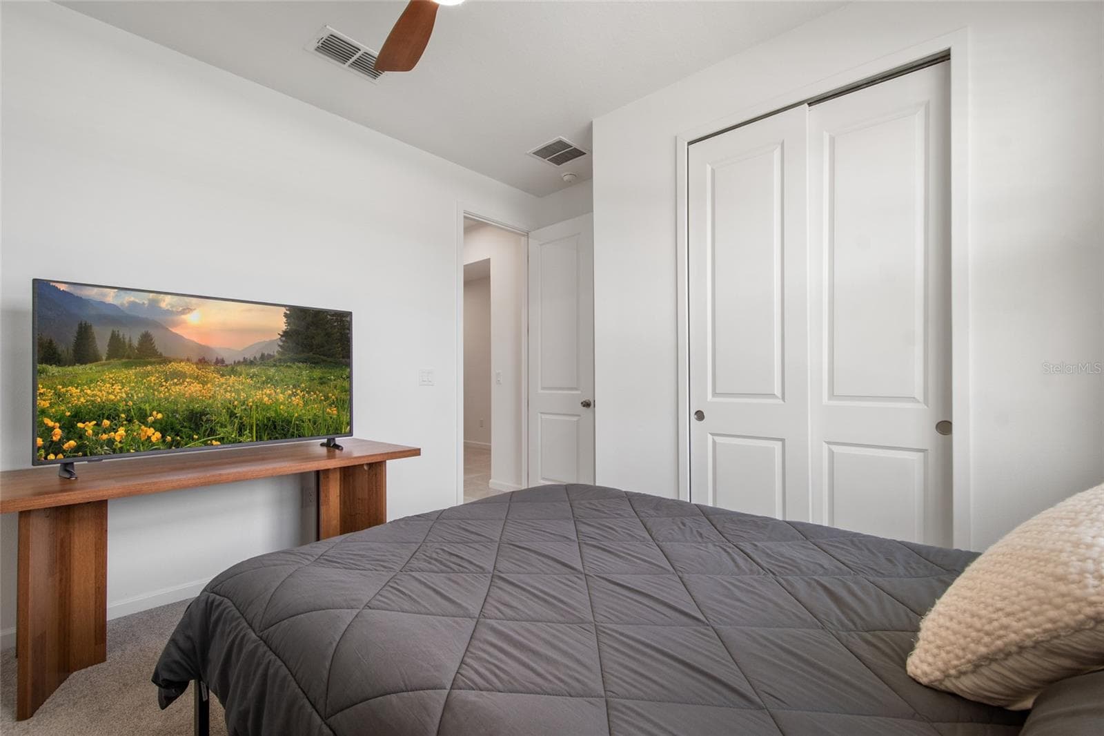 Bedroom 4 has its own privacy with bath just outside its door and ample size closet with pocketing double doors. - 2685 SWEET ACACIA DR, CLERMONT