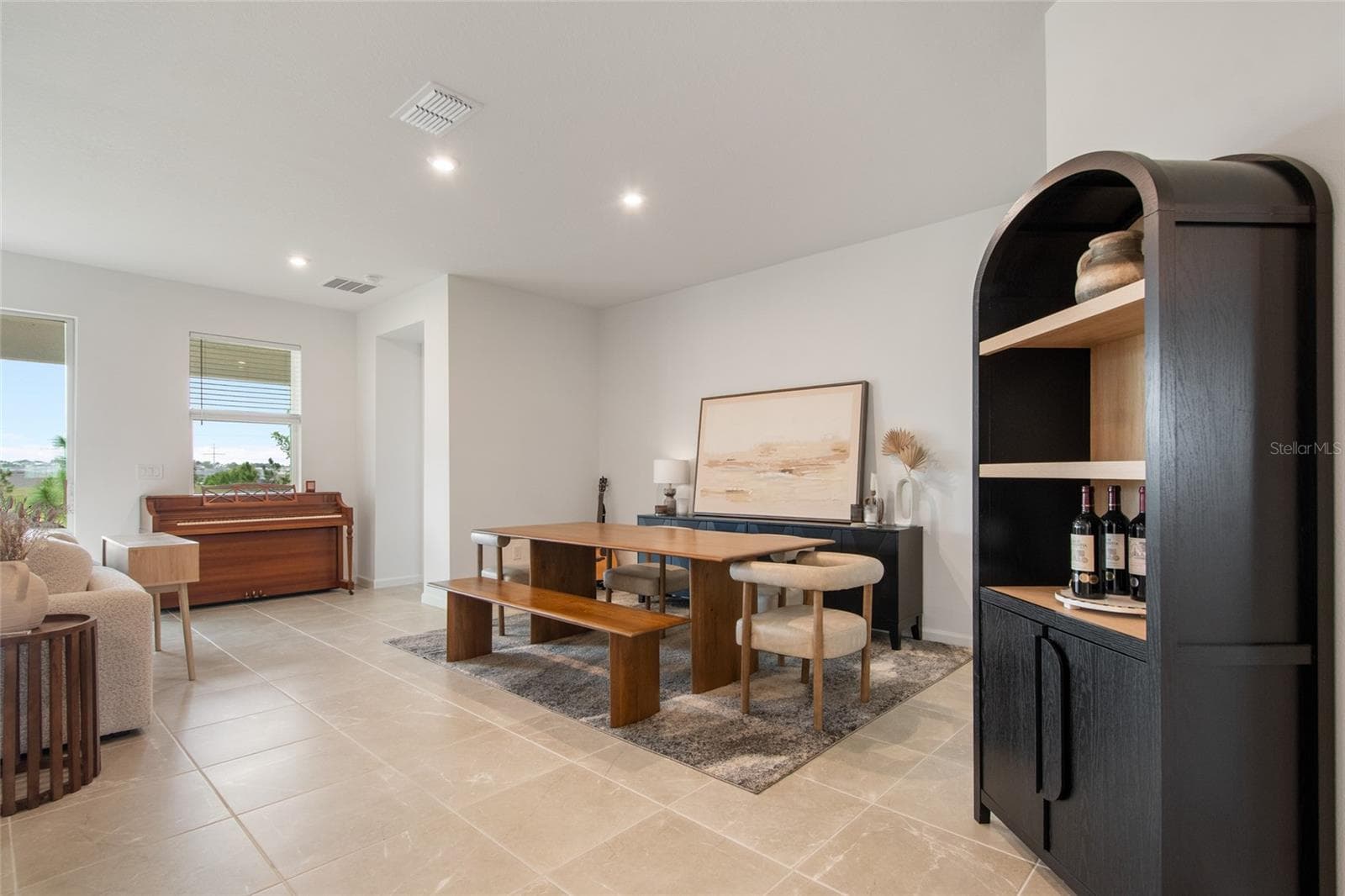 Upon entering the great room you are greeted by a free flow dedicated dining area, a view of the unobstructed rear yard and beautiful neutral tile flooring. - 2685 SWEET ACACIA DR, CLERMONT