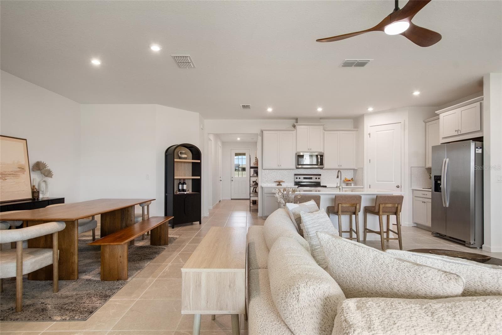 From the front foyer plenty of room for entertaining with dedicated dining, generous seating area for tv and additional seating at the breakfast bar. Easy to accommodate large family gatherings. - 2685 SWEET ACACIA DR, CLERMONT