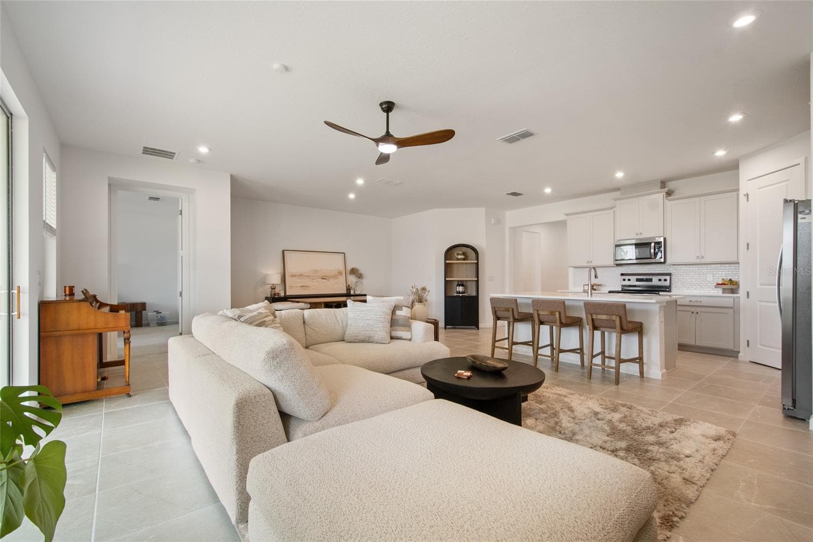 From the great room to the left is the entrance to the primary suite. Separated from all of the supporting bedrooms by the great room. - 2685 SWEET ACACIA DR, CLERMONT