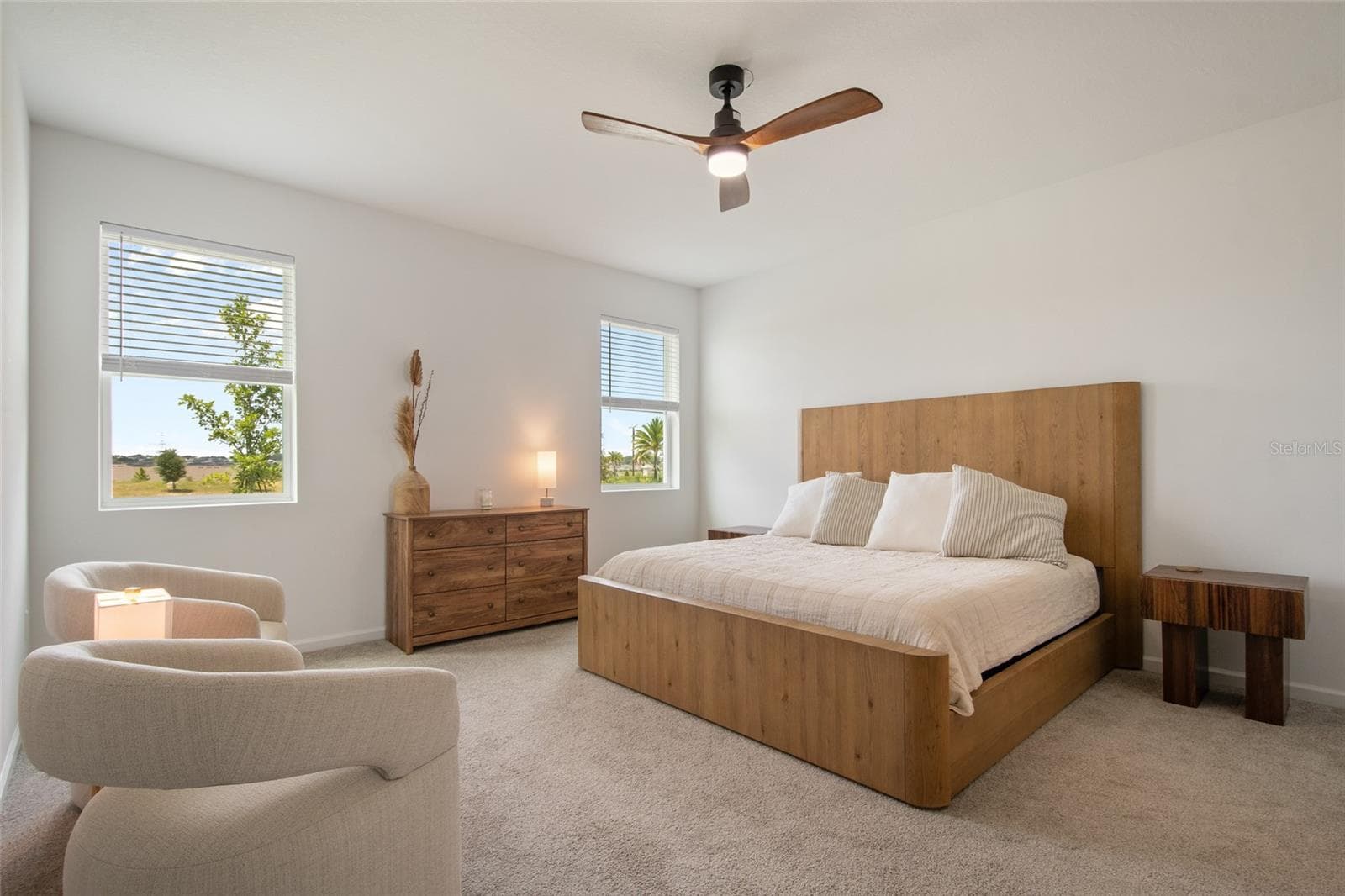 Upon entering the primary suite you notice the generous size, natural light with two windows, updated ceiling fan and windows with privacy blinds. - 2685 SWEET ACACIA DR, CLERMONT