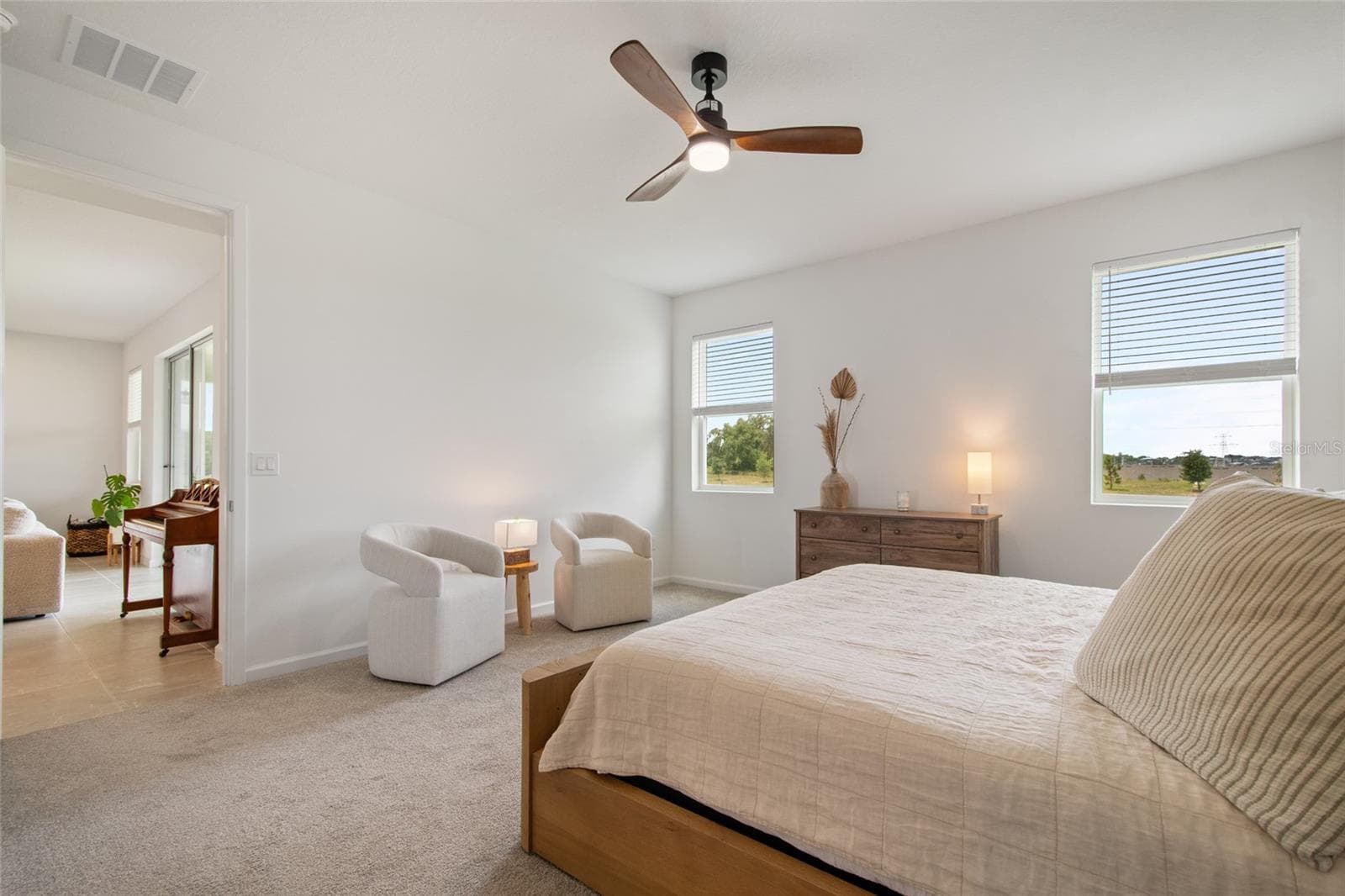 A view from primary suite back into the great room you see the generous size allows for 2 bedroom chairs and a convenient table for your favorite book or beverage. - 2685 SWEET ACACIA DR, CLERMONT