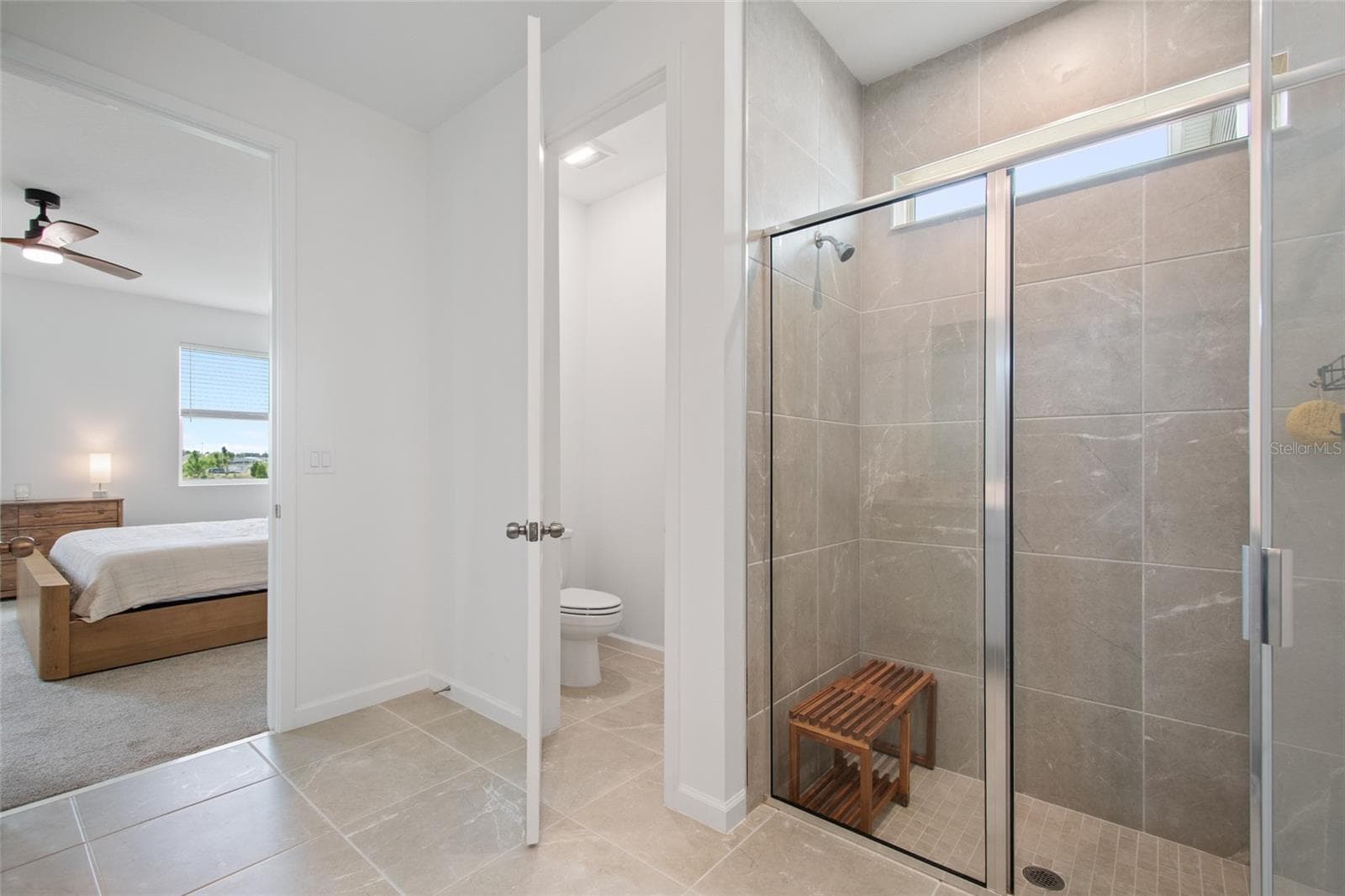 The private water closet is a plus. Walk in shower easily handles your favorite shower seat and the tile runs floor to ceiling and has a very grand feeling. - 2685 SWEET ACACIA DR, CLERMONT