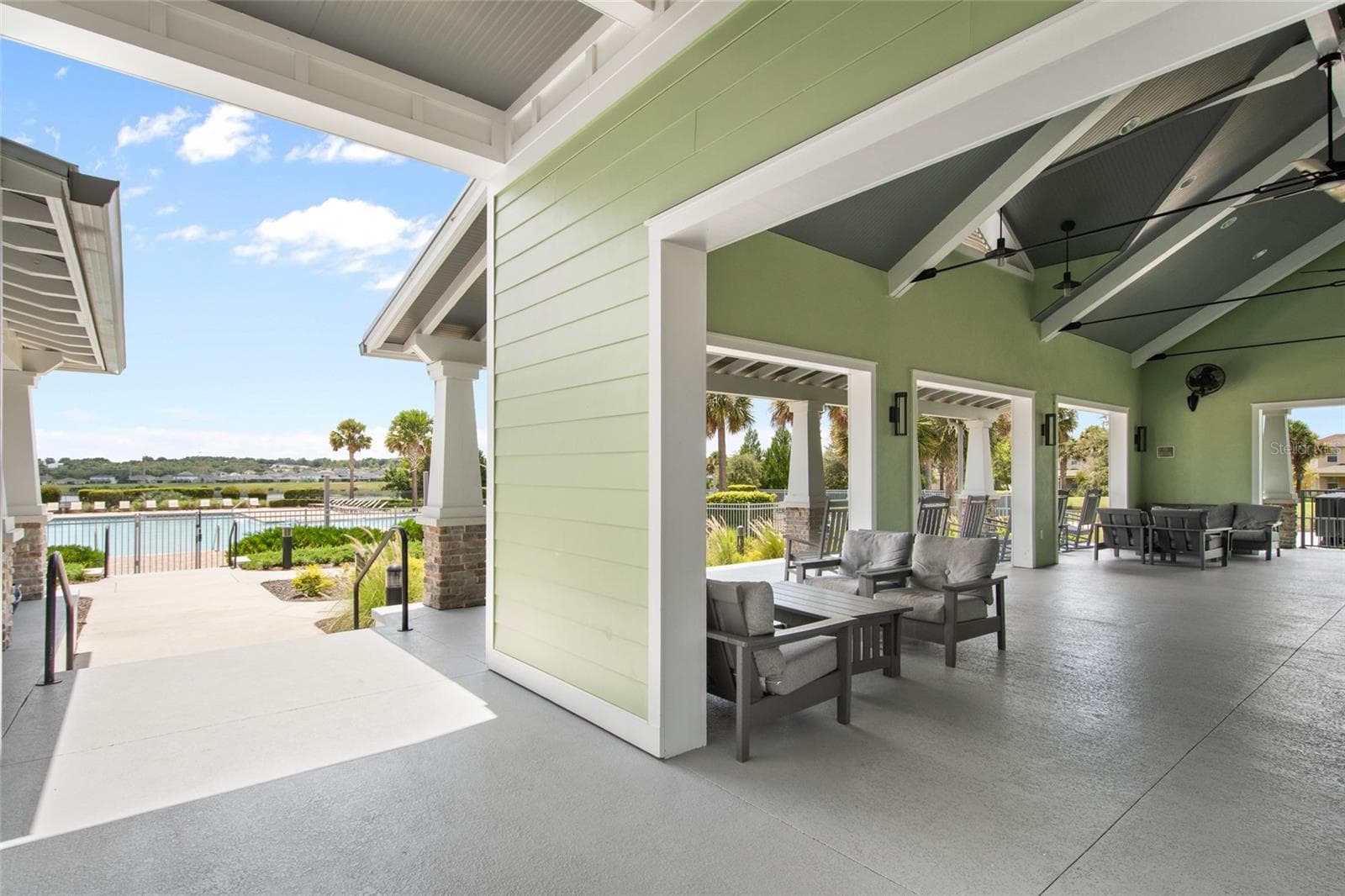 A view of the pool from the clubhouse which is equipped with seating in the shade for a break from the hot FLORIDA sun, television and restrooms - 2685 SWEET ACACIA DR, CLERMONT