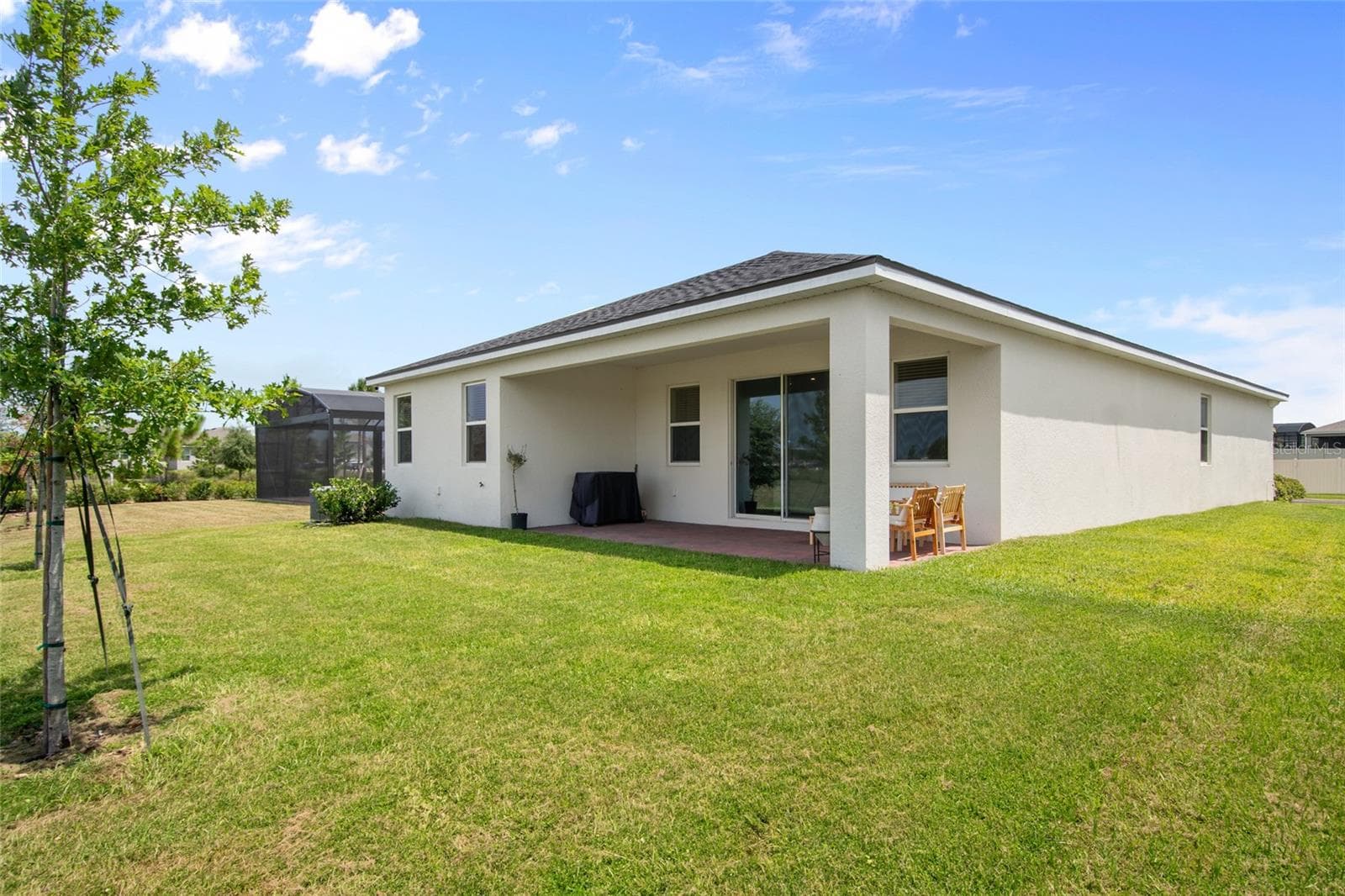 Revers view of the rear of home and the spacious covered porch. - 2685 SWEET ACACIA DR, CLERMONT