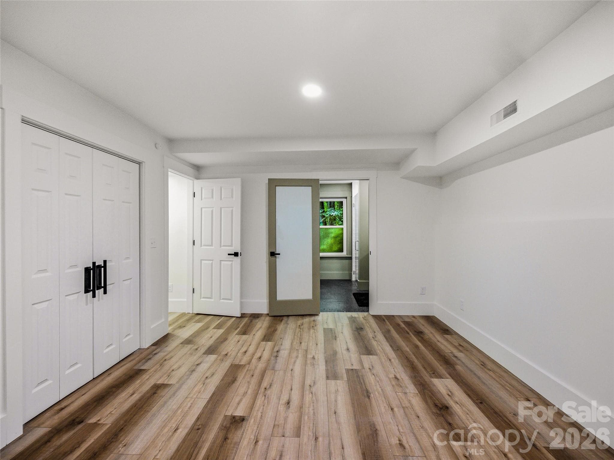 Flexible main-level bedroom or media room featuring its own private en-suite bathroom. - 81 Summer Trees Lane, Burnsville