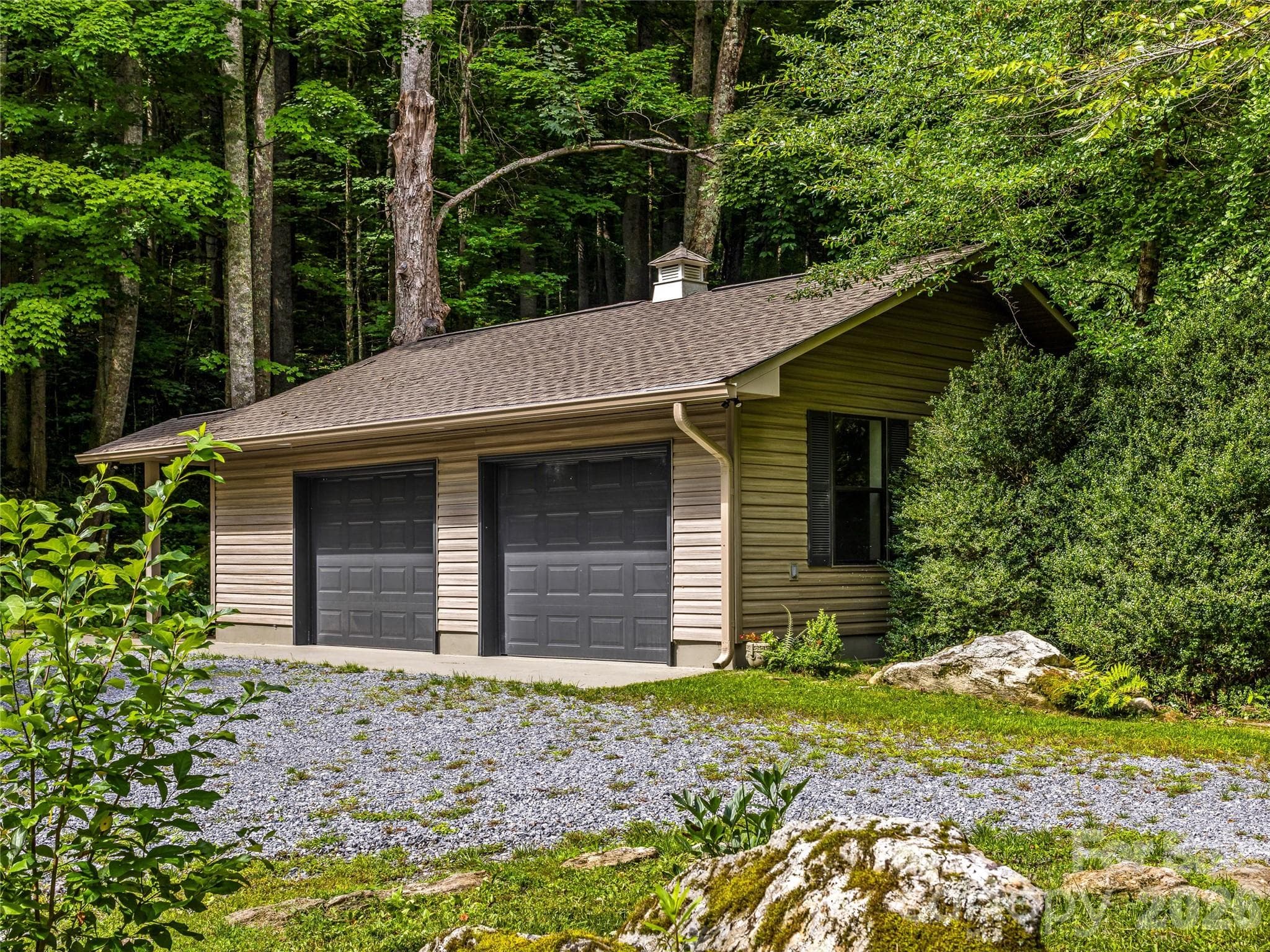 Oversized detached two-car garage featuring fresh paint, newly finished flooring, and a spacious attic for additional storage. - 81 Summer Trees Lane, Burnsville