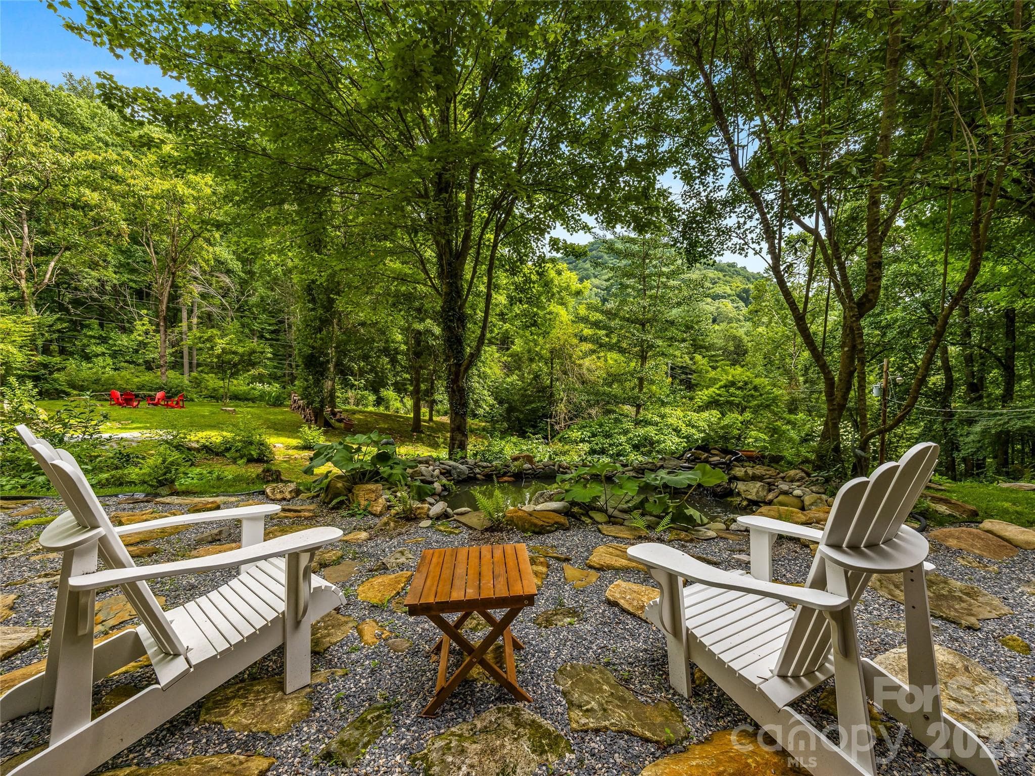 Relax beside the tranquil pond and enjoy the gently sloping landscape with picturesque views of a neighboring antique barn. - 81 Summer Trees Lane, Burnsville