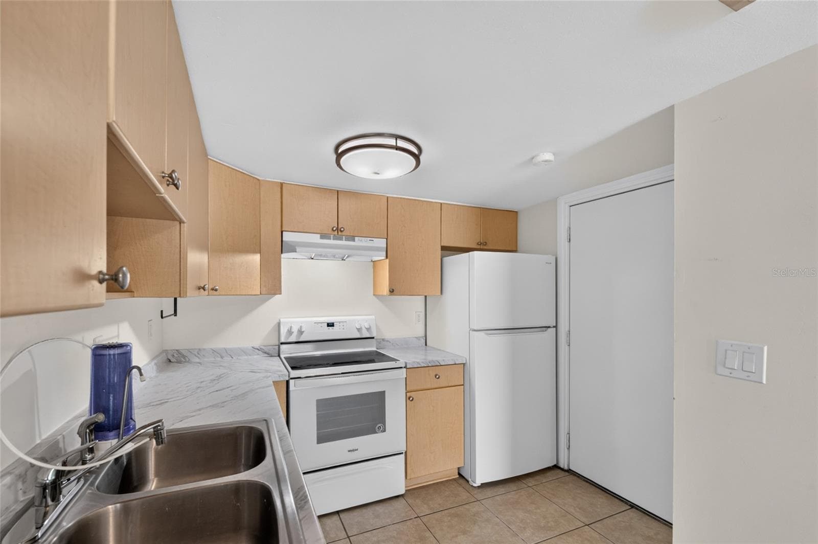 Kitchen with its own entry door and closet space for more storage - 3461 CLARK RD #160, SARASOTA