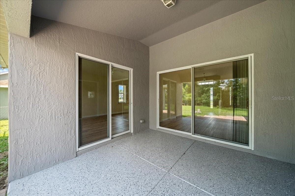 Lanai with doors leading into owner's suite and living room - 6305 SW 63RD ST, OCALA