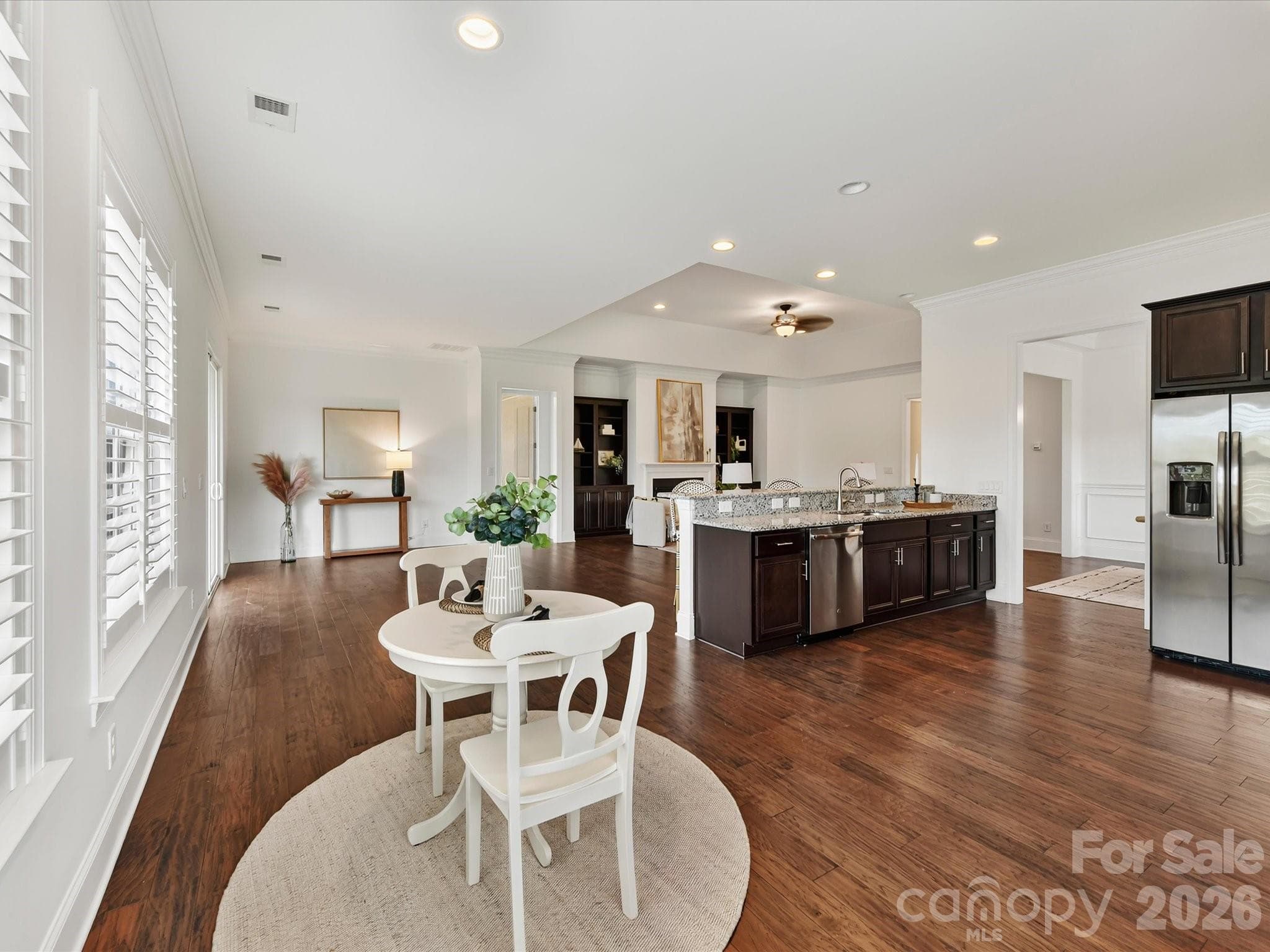 Kitchen flows seamlessly into the bright breakfast nook, where abundant windows and open sightlines create an inviting space for casual dining. - 13003 Riley Grace Lane, Cornelius