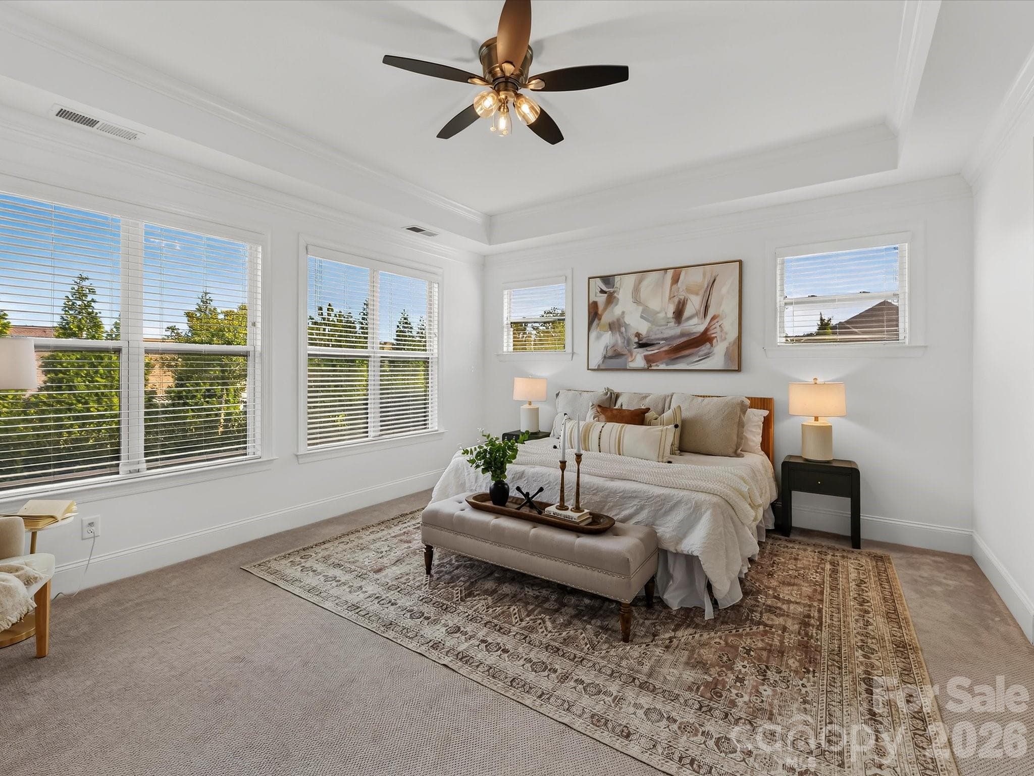 Spacious primary suite features a deep tray ceiling, abundant natural light, and a serene layout offering a comfortable private retreat. - 13003 Riley Grace Lane, Cornelius