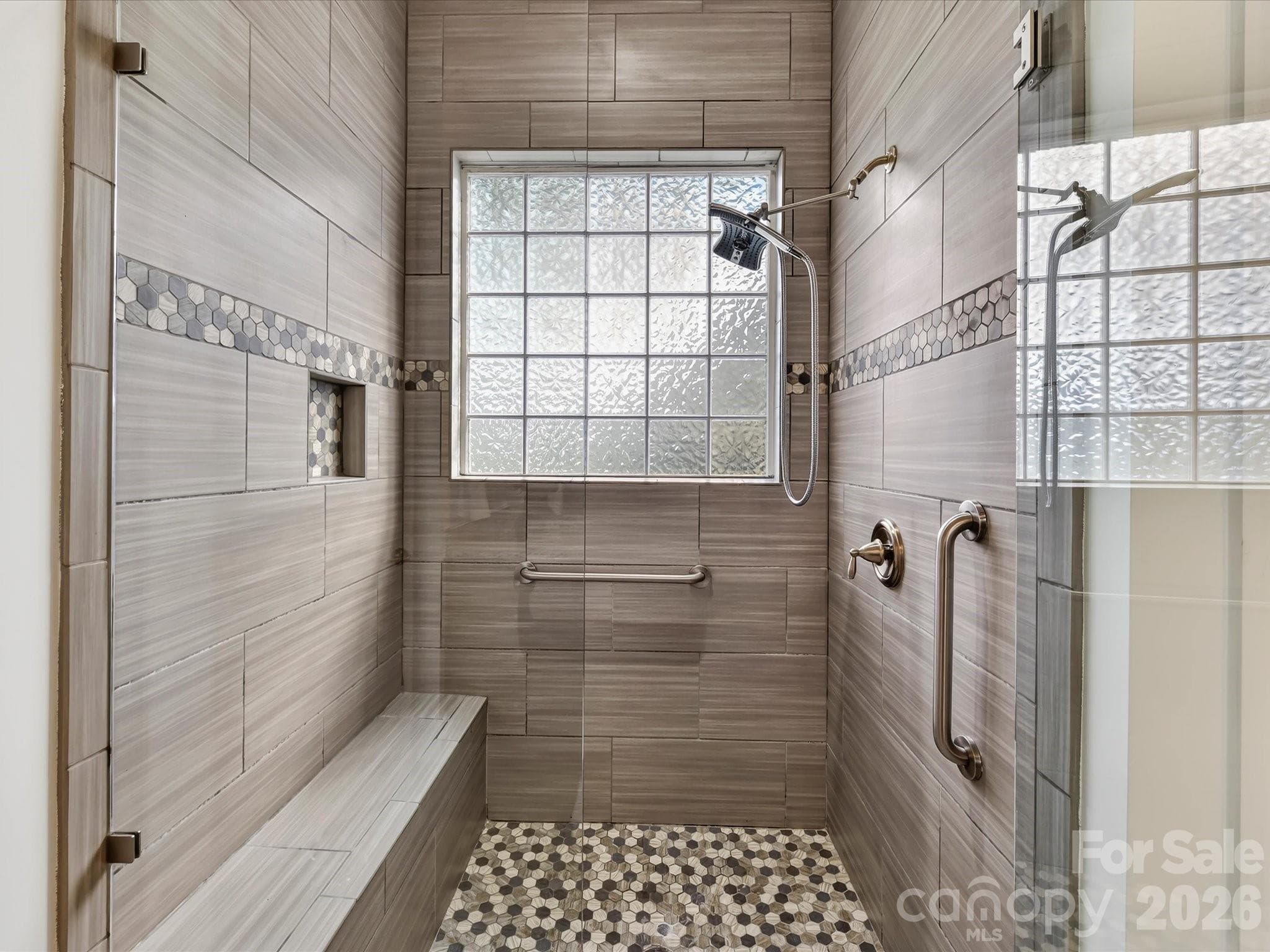 Beautiful, tiled walk in shower with stone tile accents & bench for convenience. - 13003 Riley Grace Lane, Cornelius