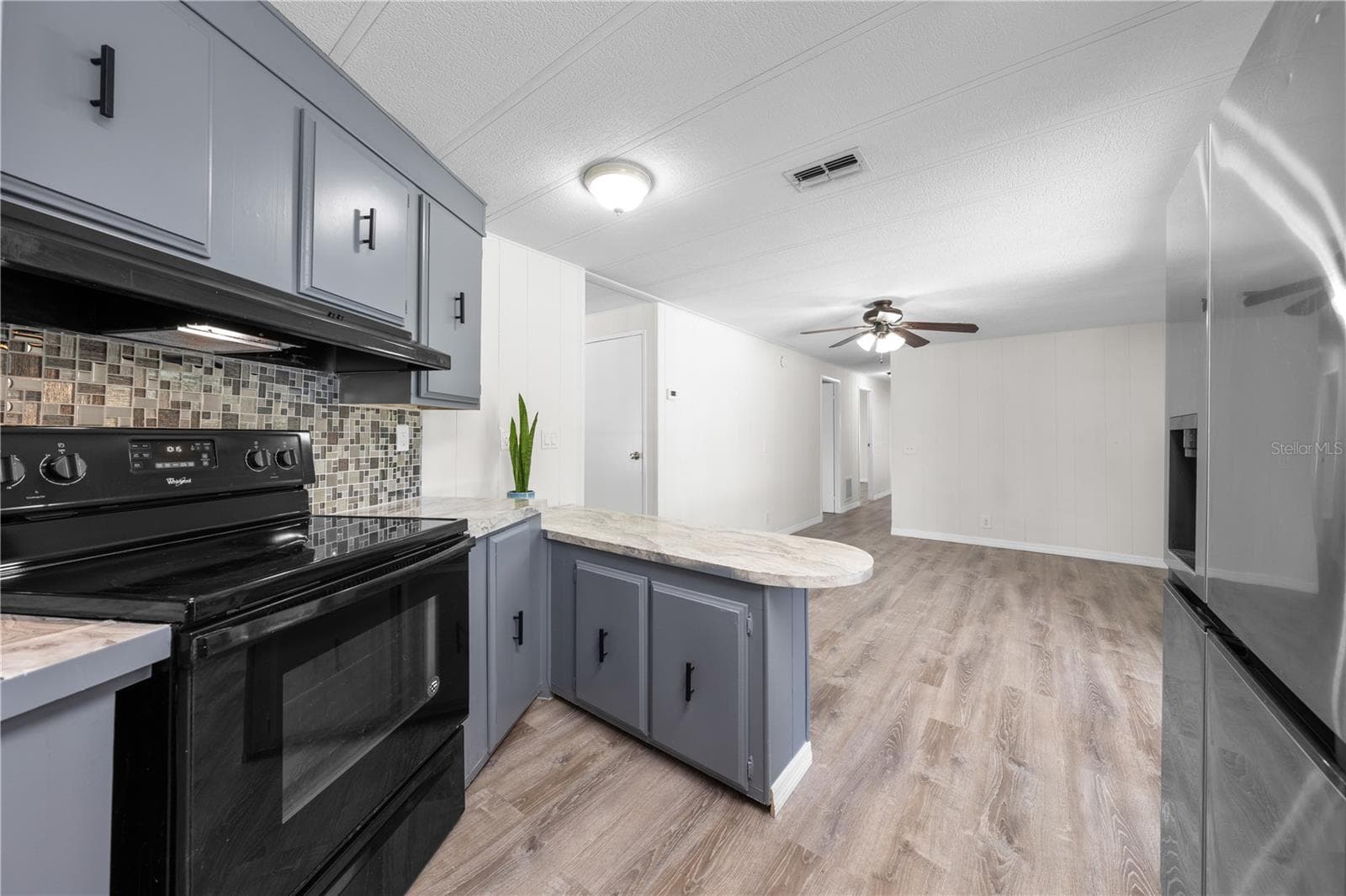 Another view from kitchen into flex family room and hallway. - 5601 LAKE LIZZIE DR, ST CLOUD