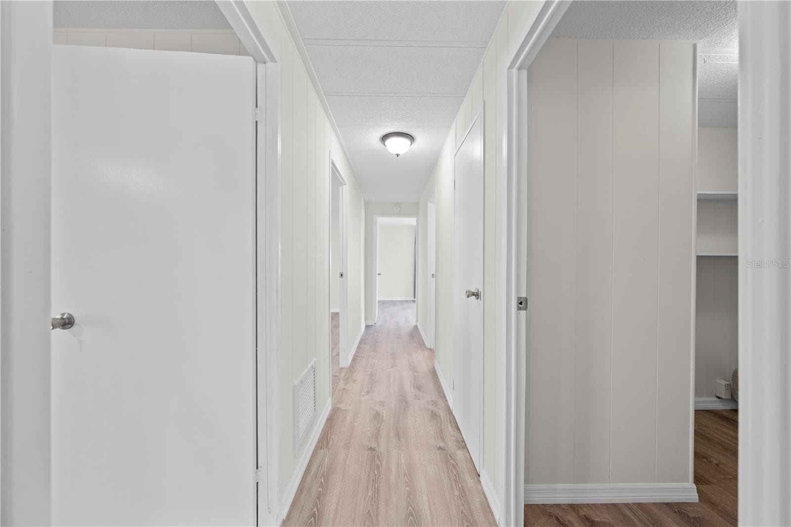 Hallway leading to 3 bedrooms, 2 bathrooms and indoor laundry - 5601 LAKE LIZZIE DR, ST CLOUD