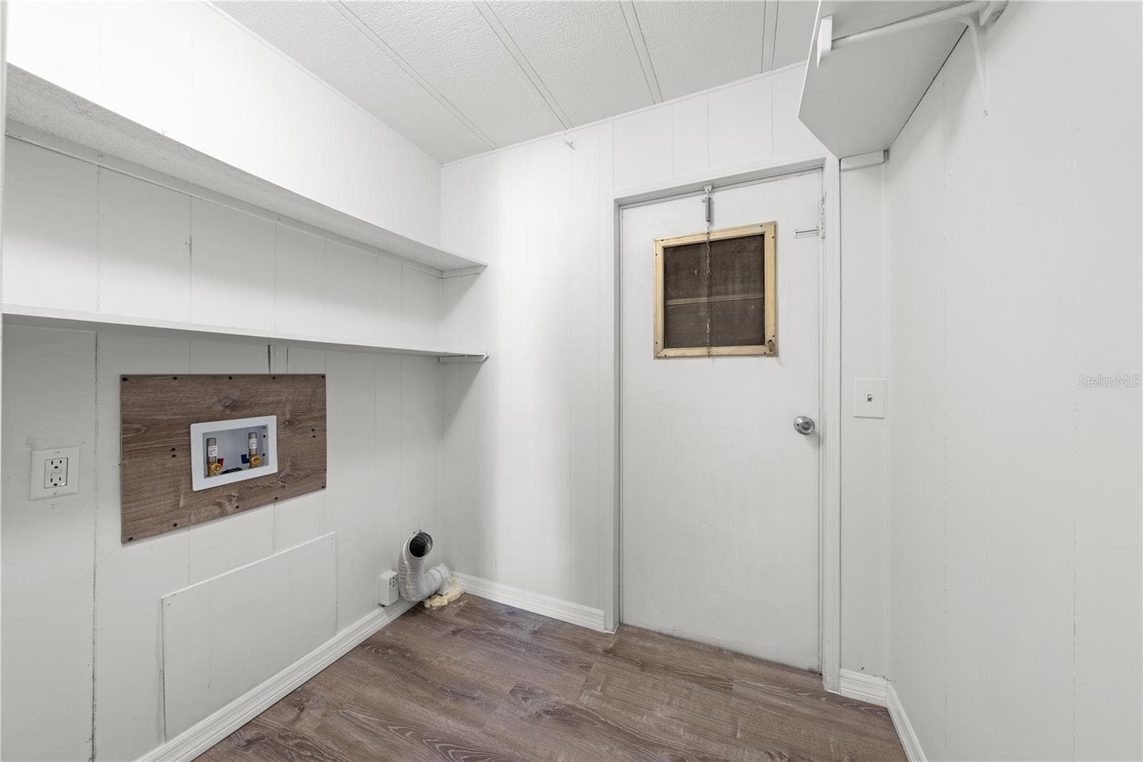 Indoor laundry room with door to Florida Room - 5601 LAKE LIZZIE DR, ST CLOUD