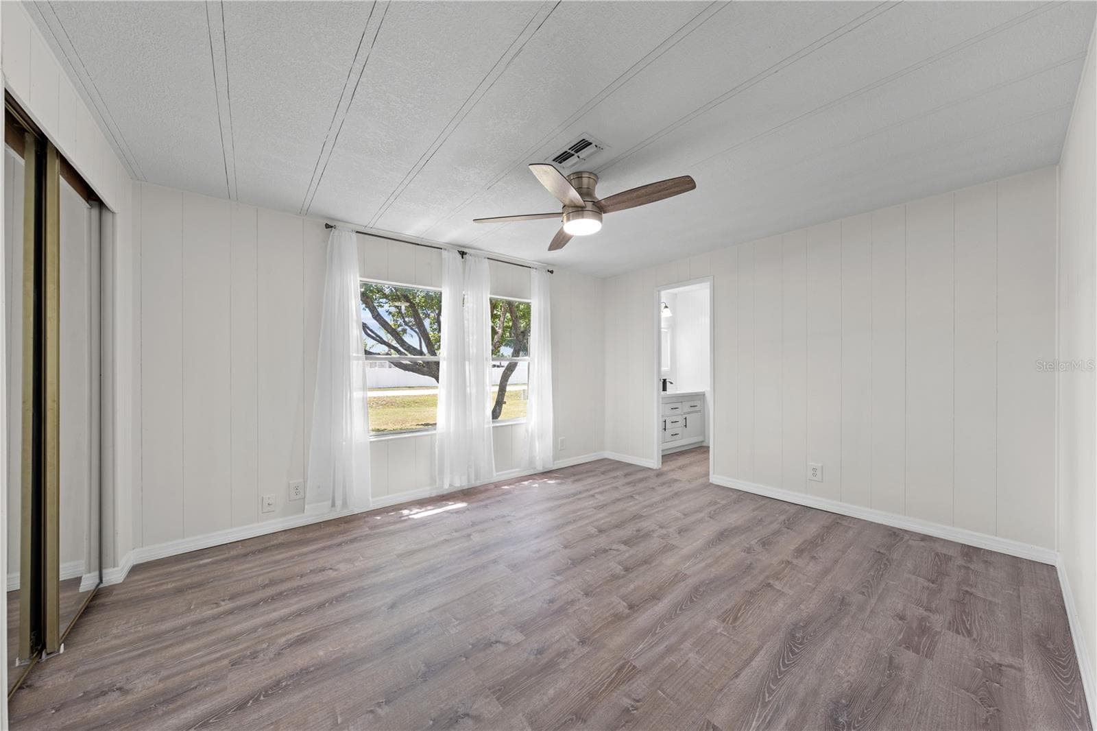 Primary bedroom with a front yard view - 5601 LAKE LIZZIE DR, ST CLOUD