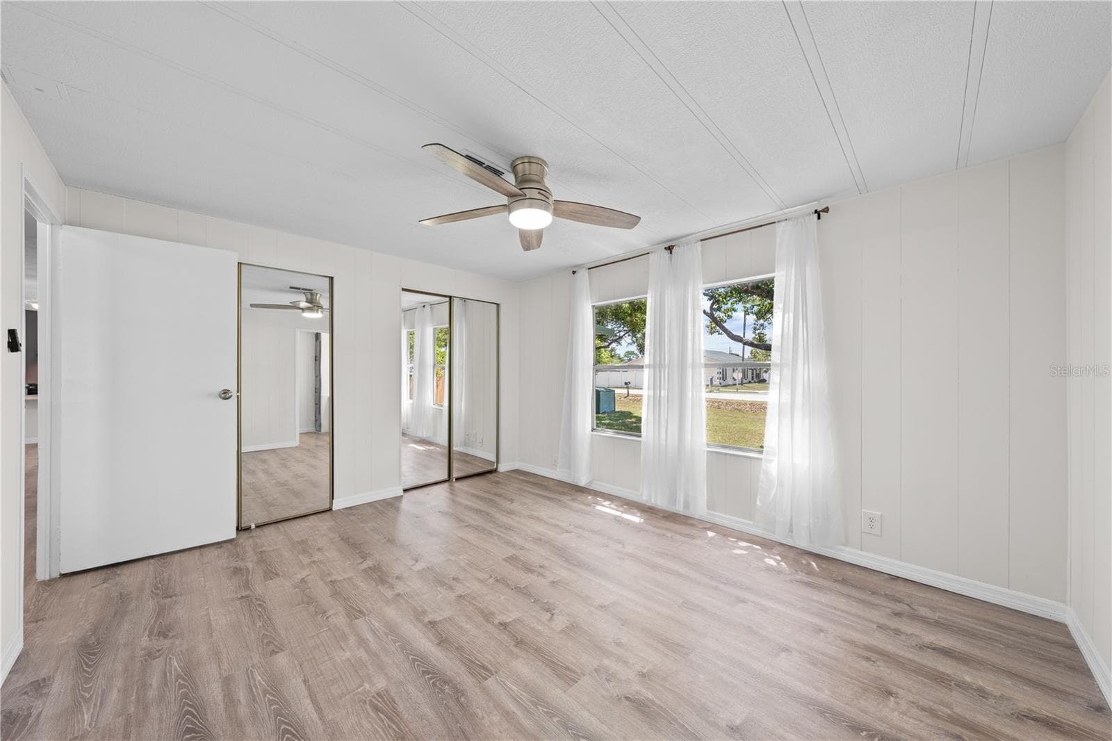 Primary bedroom with double mirrored closets - 5601 LAKE LIZZIE DR, ST CLOUD