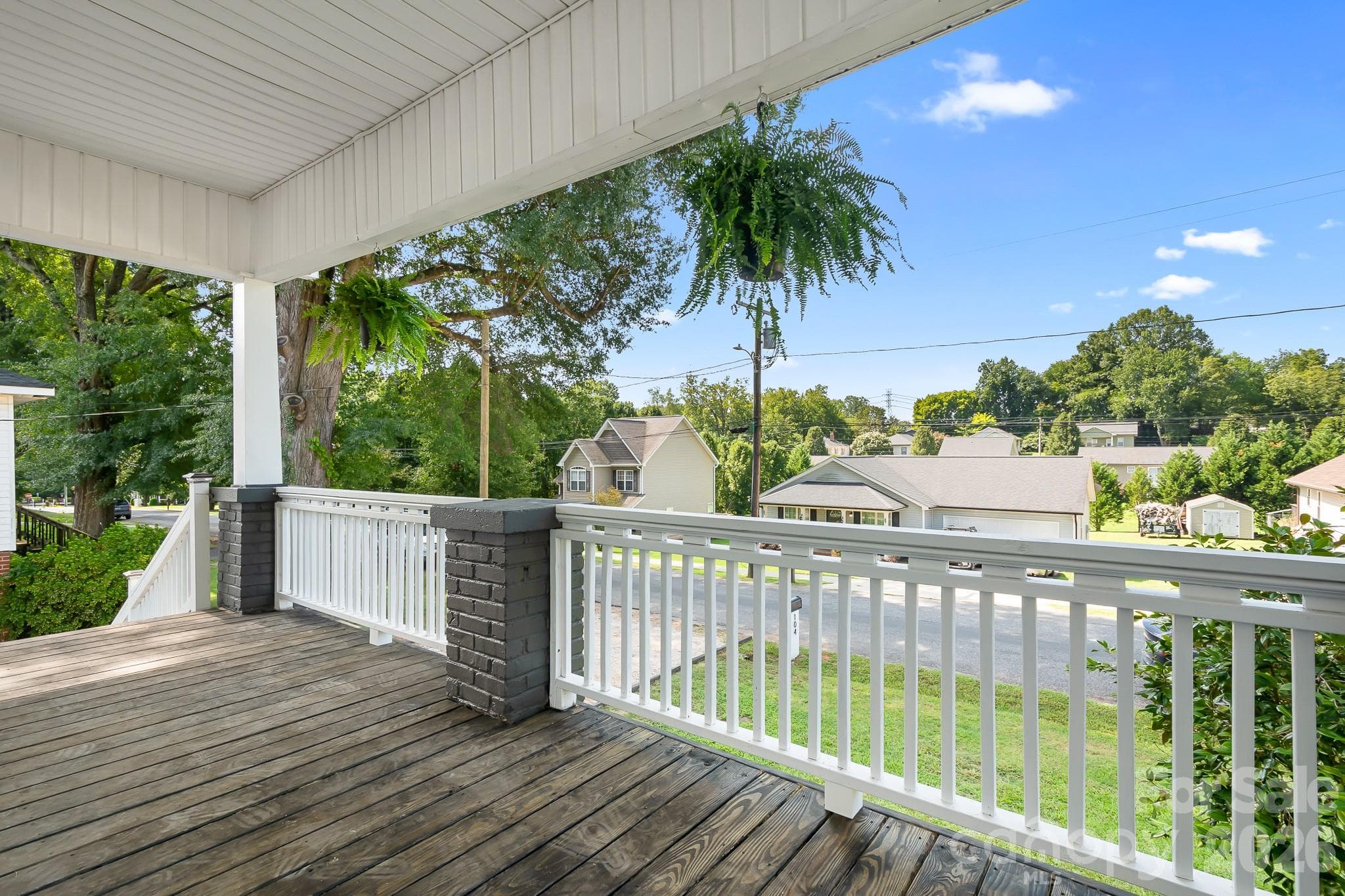 Welcoming covered front porch offering a relaxing spot to unwind and enjoy the surrounding views - 104 1st Avenue, China Grove