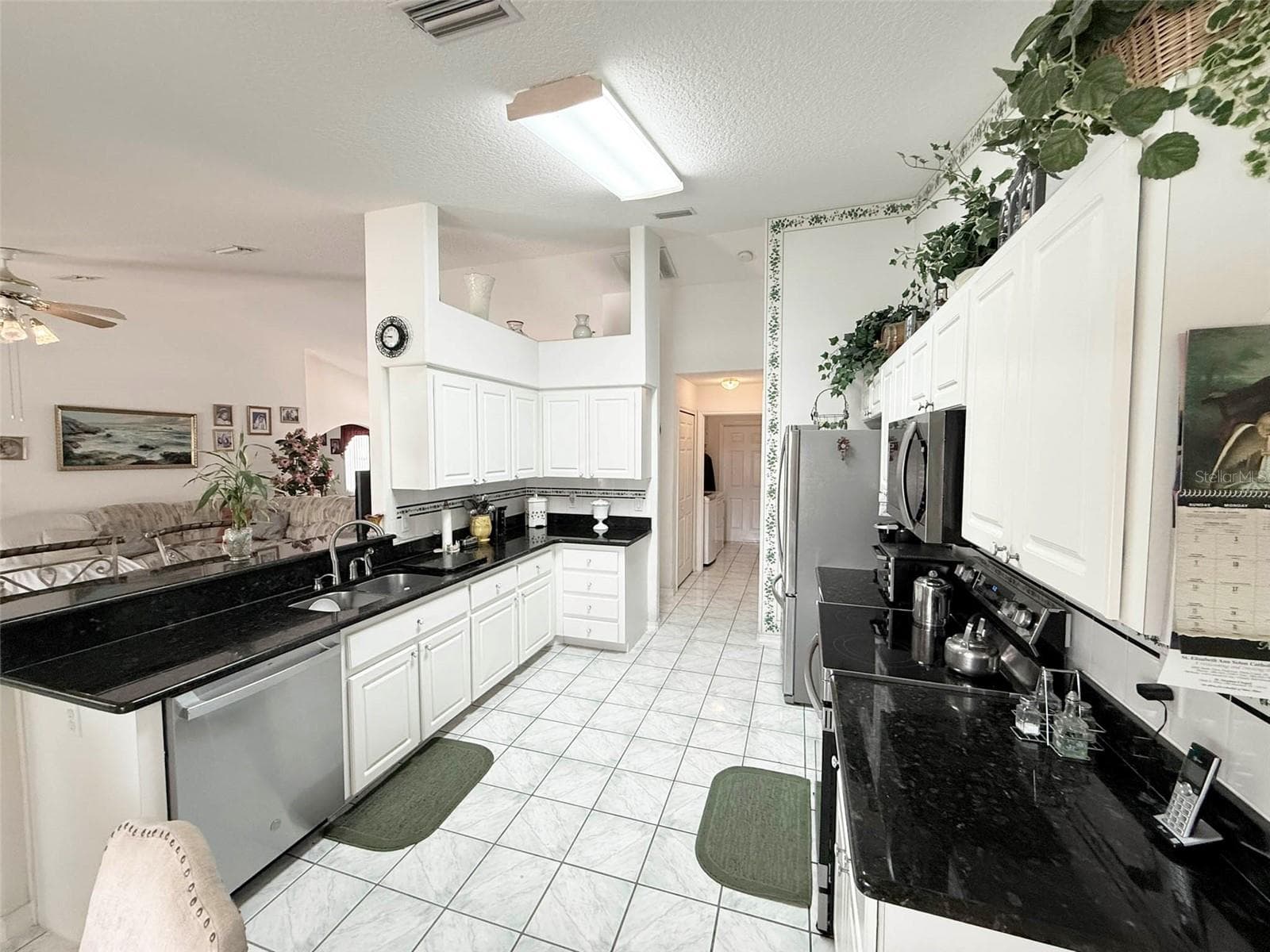 Kitchen with granite countertops & stainless steel appliances - 22 COLORADO DR, PALM COAST