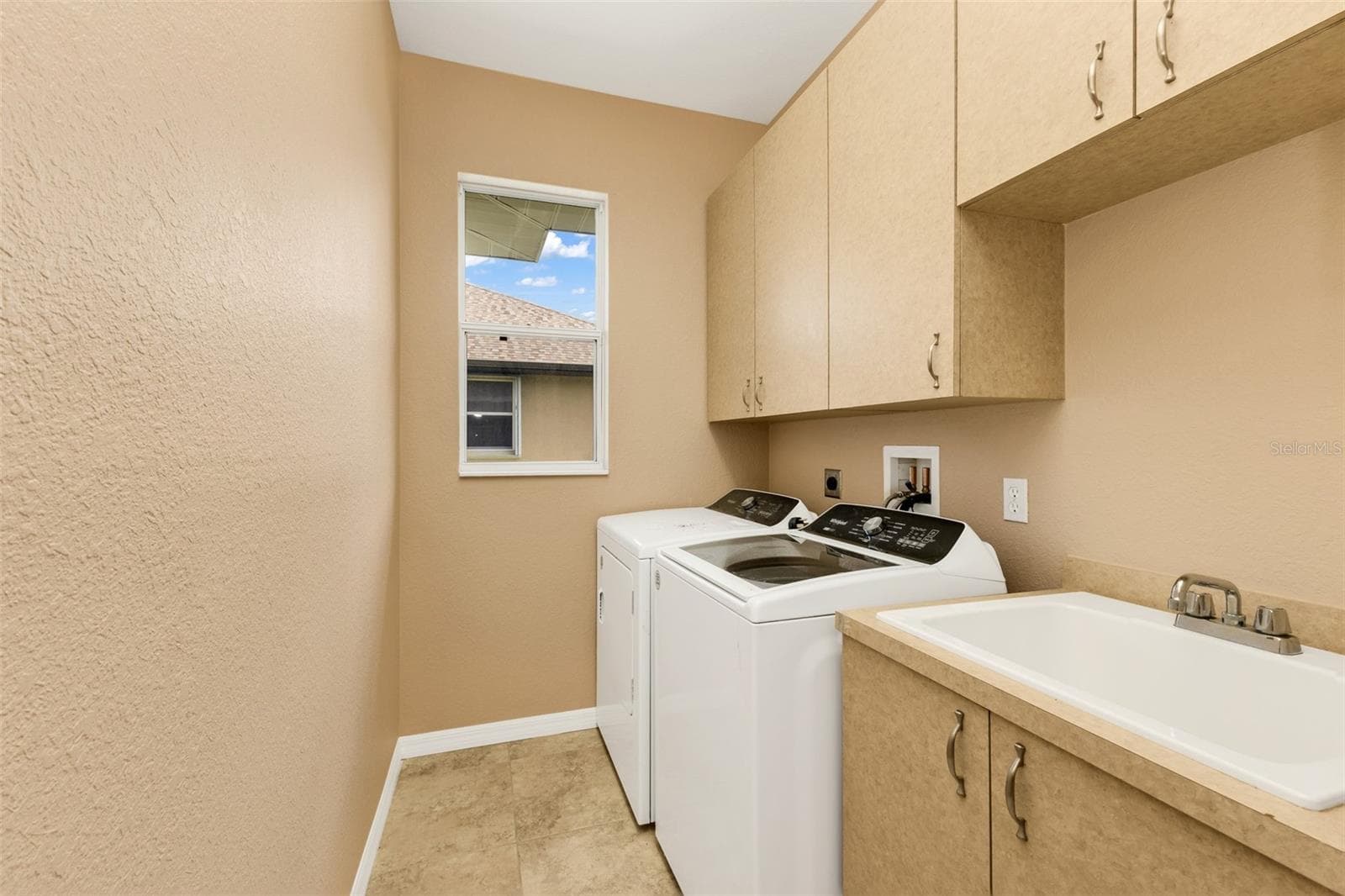 Laundry room w utility sink and cabinets - 2420 PEBBLE CREEK PL, PORT CHARLOTTE