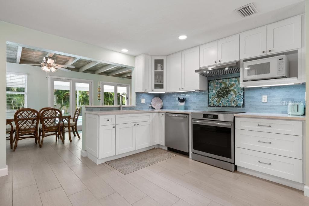 Kitchen is the center of the home - 406 BAY PALMS DR, HOLMES BEACH