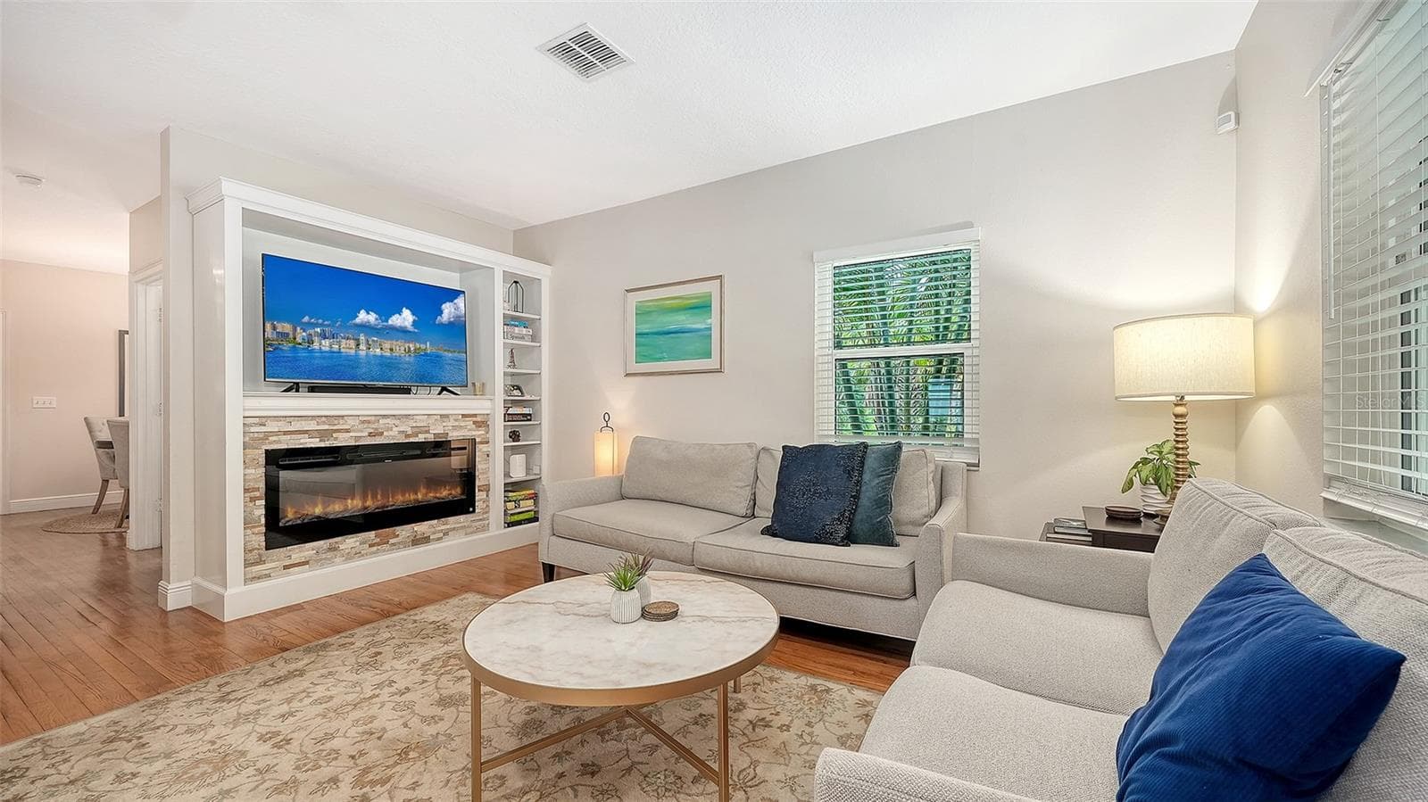 Expansive living area offers an inviting blend of comfort and luxury with hardwood flooring, fireplace, and abundant natural light. - 1685 6TH ST, SARASOTA