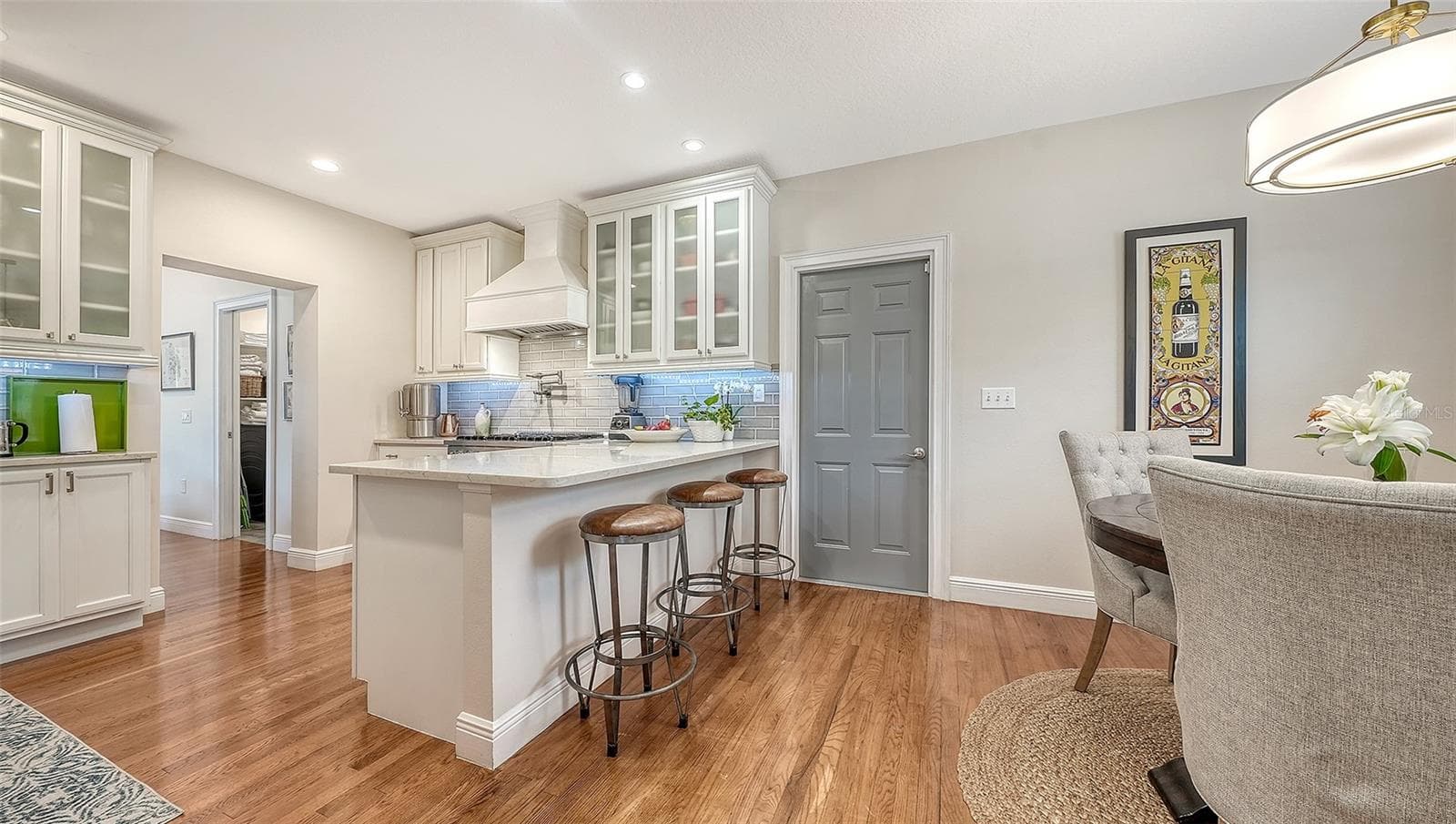 Chef’s kitchen features custom cabinetry, quartz countertops, premium stainless appliances, and a generous center island designed for effortless entertaining. - 1685 6TH ST, SARASOTA
