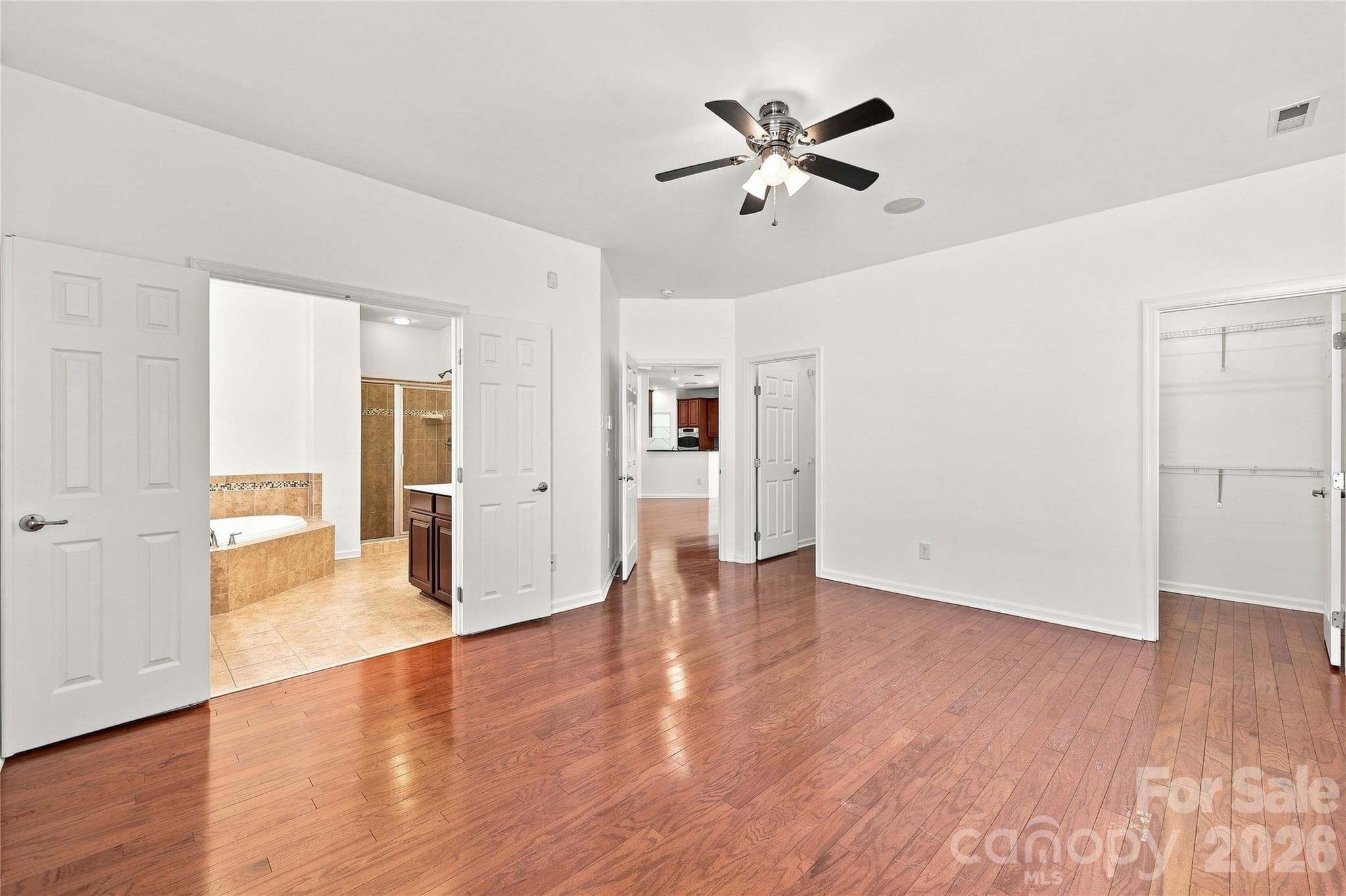 Primary bedroom with ceiling fan, double closets and ensuite bath - 593 Harrison Drive NW, Concord