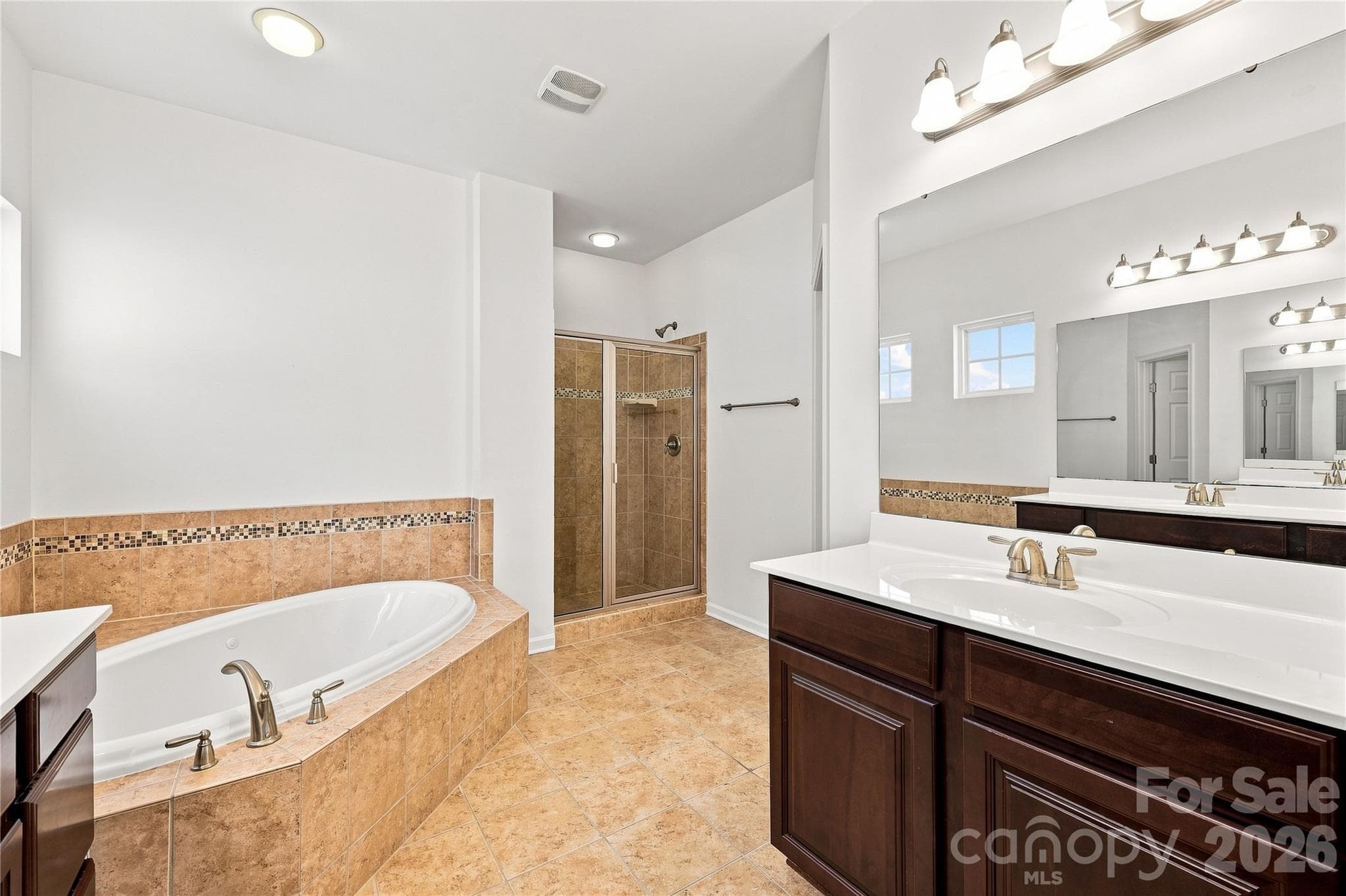 Primary bathroom with double sinks, jetted tub and separate shower - 593 Harrison Drive NW, Concord