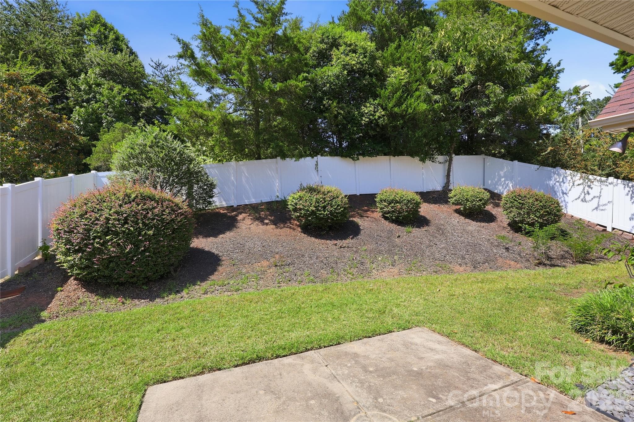 Landscaped rear yard with privacy white vinyl fencing - 593 Harrison Drive NW, Concord