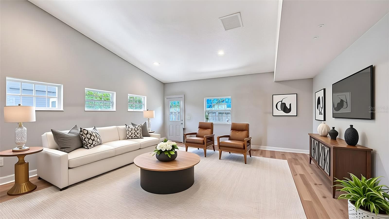 Virtually staged alternative living-room configuration demonstrates the impressive versatility of the downstairs bonus area. - 1685 6TH ST, SARASOTA
